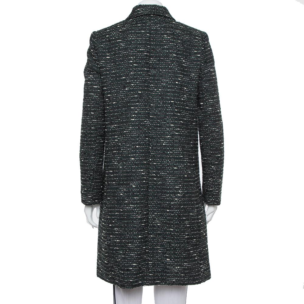 This fine women's coat from M Missoni deserves a special place in your closet. Grand in black, it displays a simple collar, button closure, and long sleeves. Made from tweed, this beautiful coat can be teamed with a dress underneath for a