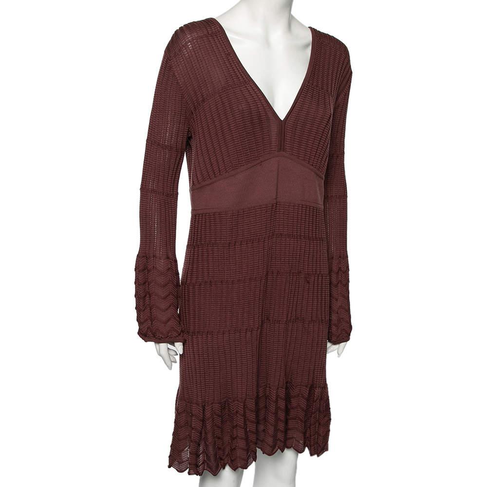 Flawlessly feminine and chic this dress from M Missoni grants you endless beauty and demure The V neck dress has been tailored using burgundy knit fabric and is highlighted with pleated formations at the hem. It has long sleeves and a comfortable