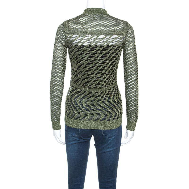 This exquisitely designed cardigan by M Missoni captures casual aesthetics with modern style. This crochet cardigan comes in a metallic green color and has subtle glamour. It features a collar, front button closure, long sleeves, and a good fit.

