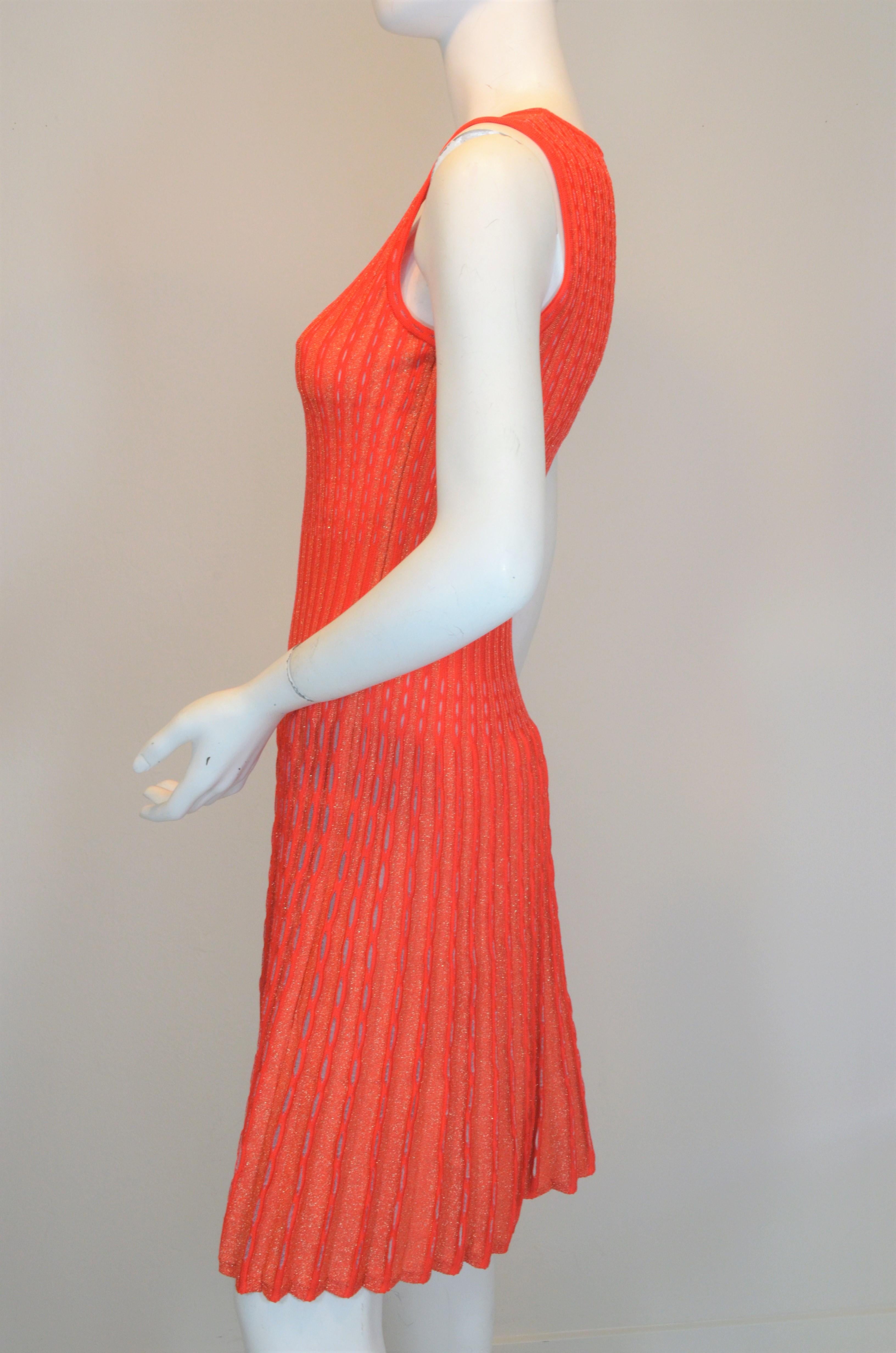 M Missoni fit and flare knitted dress is featured in a red and orange color with a shimmering, metallic  threading throughout. Dress is labeled size 42, made in Italy. 

Measurements:
Bust 30”, waist 26”, hips 34”, length 37” 