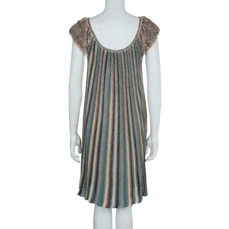 Treasure this adorable and modish Lurex knit dress tailored by M Missoni. It is crafted from viscose, polyethylene and nylon blend, featuring beautiful fringed short sleeves. This dress is accented with a square shaped neckline.

