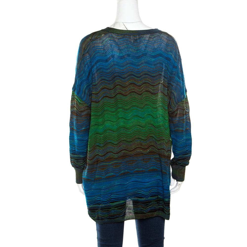 M Missoni delights us with this wonderful cardigan. It is knit from a Cotton-Polyester blend and styled with front buttons, long sleeves and patterns of multiple colours all over. The oversized cardigan will be a luxurious addition to your