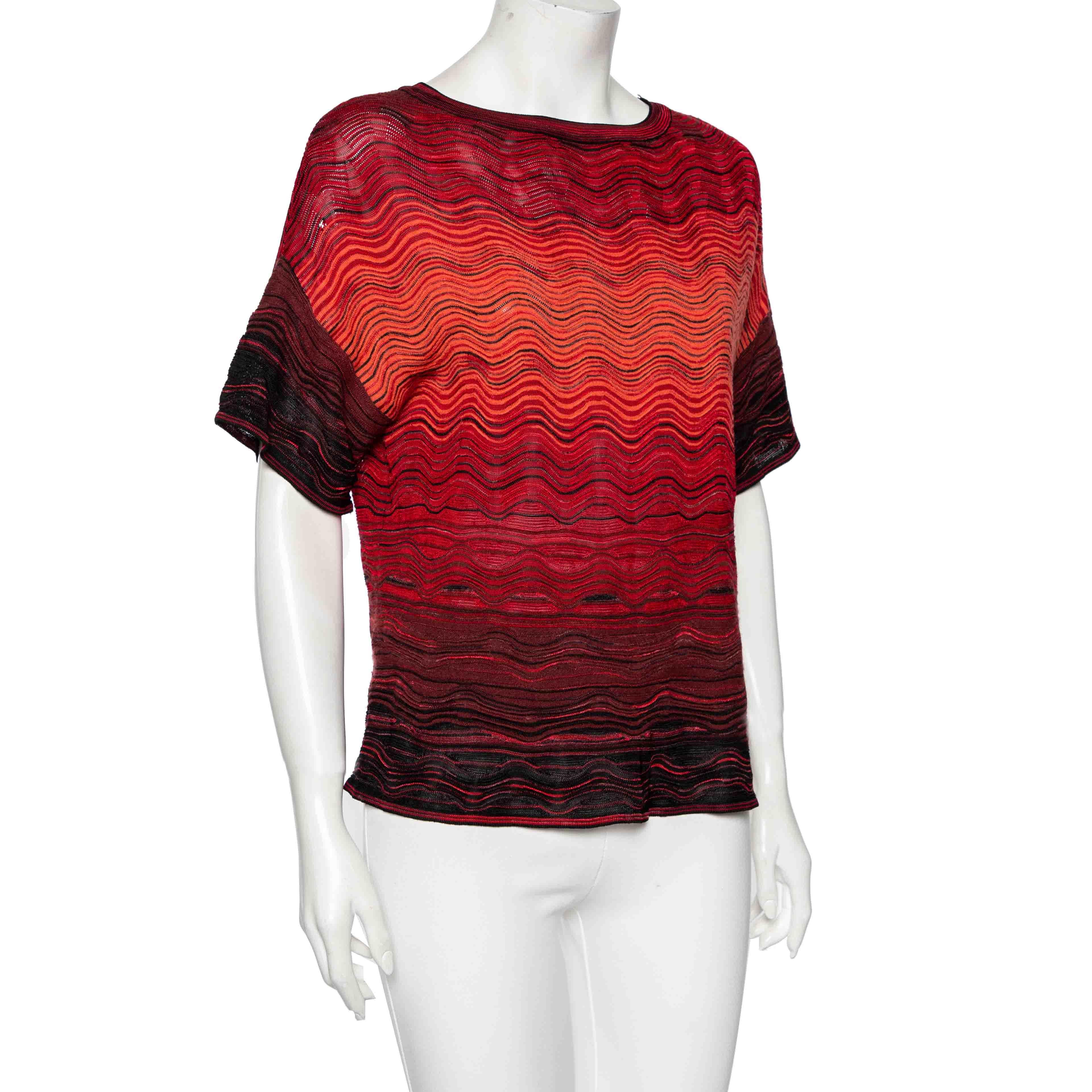 Oversized top is in fashion and to add a classy touch to it M Missoni has crafted a beautiful piece. It has a simple round neckline and short sleeves along with a wave pattern all over. This multicolored top will go finely with a tight pair of jeans.