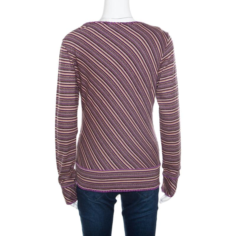M Missoni gives you this top and cardigan set to complement your casual attire. Cut from a blend of fabrics, the set is designed in an identical pattern with a smartly shaped sleeveless top and a full sleeves buttoned cardigan. The purple striped