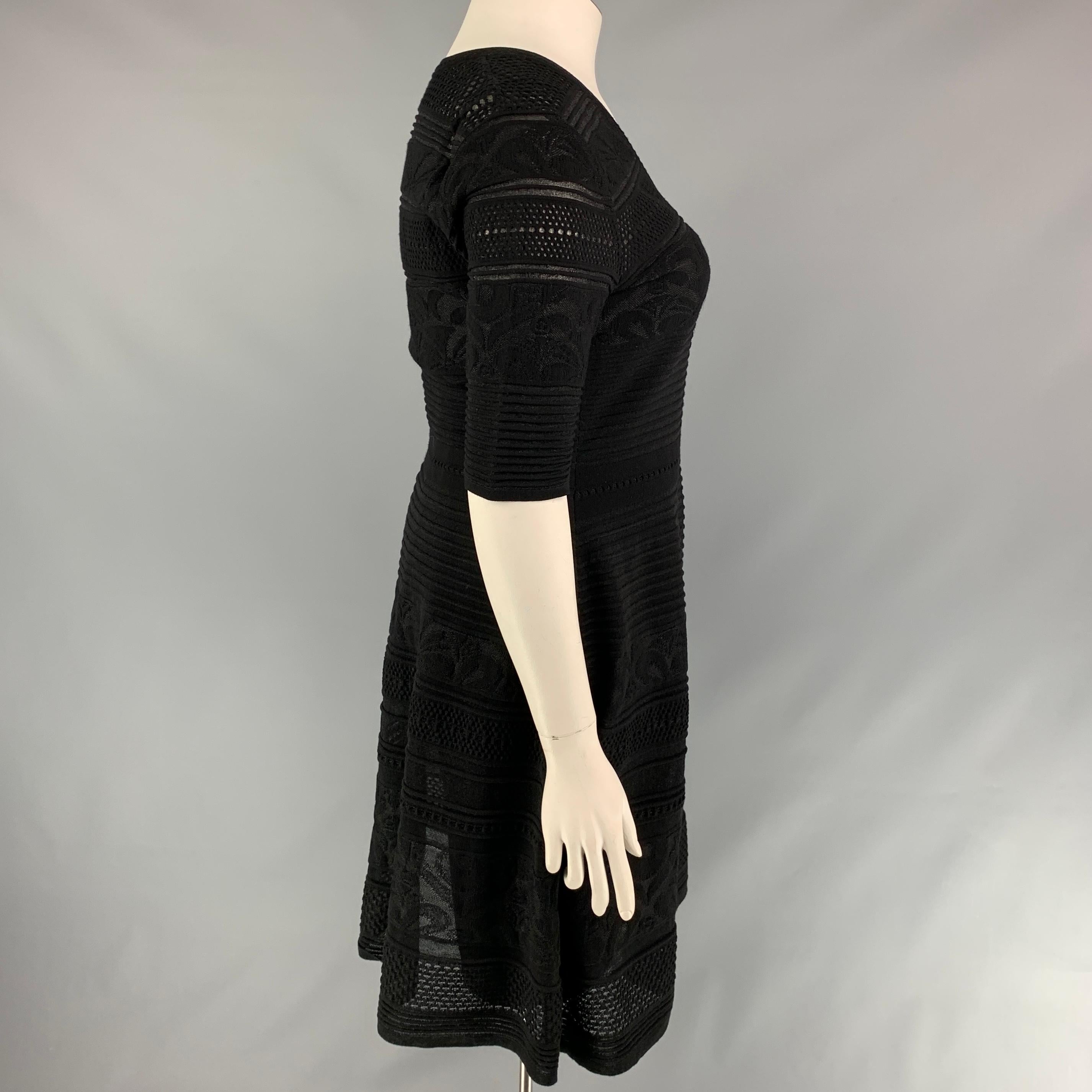 M MISSONI dress comes in a black knitted material with a slip liner featuring a a-line style, short sleeves, and a v-neck. Made in Italy. 

Very Good Pre-Owned Condition.
Marked: 48

Measurements:

Shoulder: 17 in.
Bust: 36 in.
Waist: 33 in.
Hip: 45