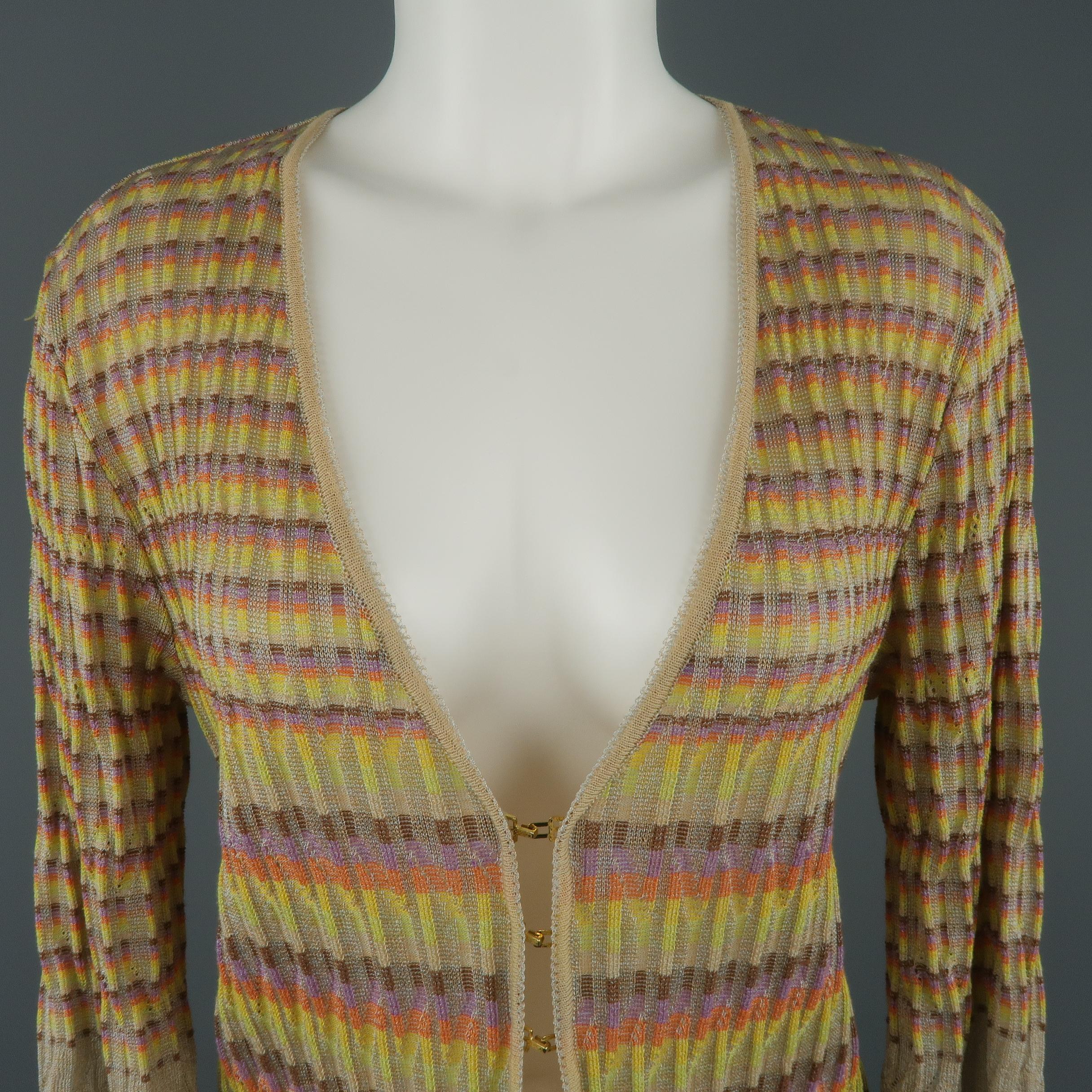 M MISSONI cardigan comes in a metallic beige cable like textured knit with rainbow stripe pattern throughout, v neck cropped three quarter sleeves, and three gold tone hook eye closures. Matching top available separately. Made in Italy.
 
Excellent