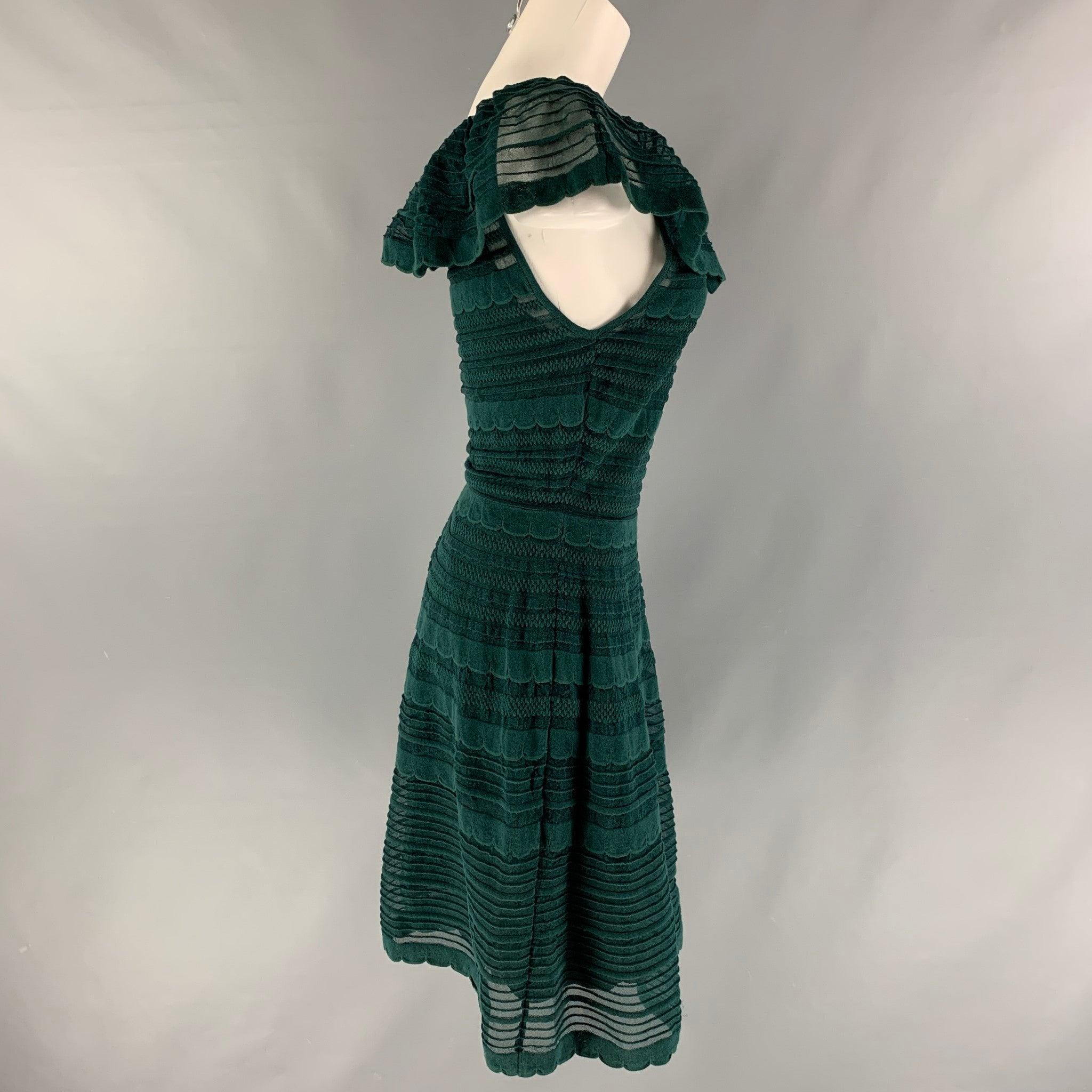 M MISSONI A-line dress comes in a green cotton blend knit fabric featuring a ruffle neckline design. Made in Italy.Very Good Pre-Owned Condition. Minor sign of wear.  

Marked:   42 IT 

Measurements: 
  Bust: 32 inches Waist: 28 inches Hip: 43