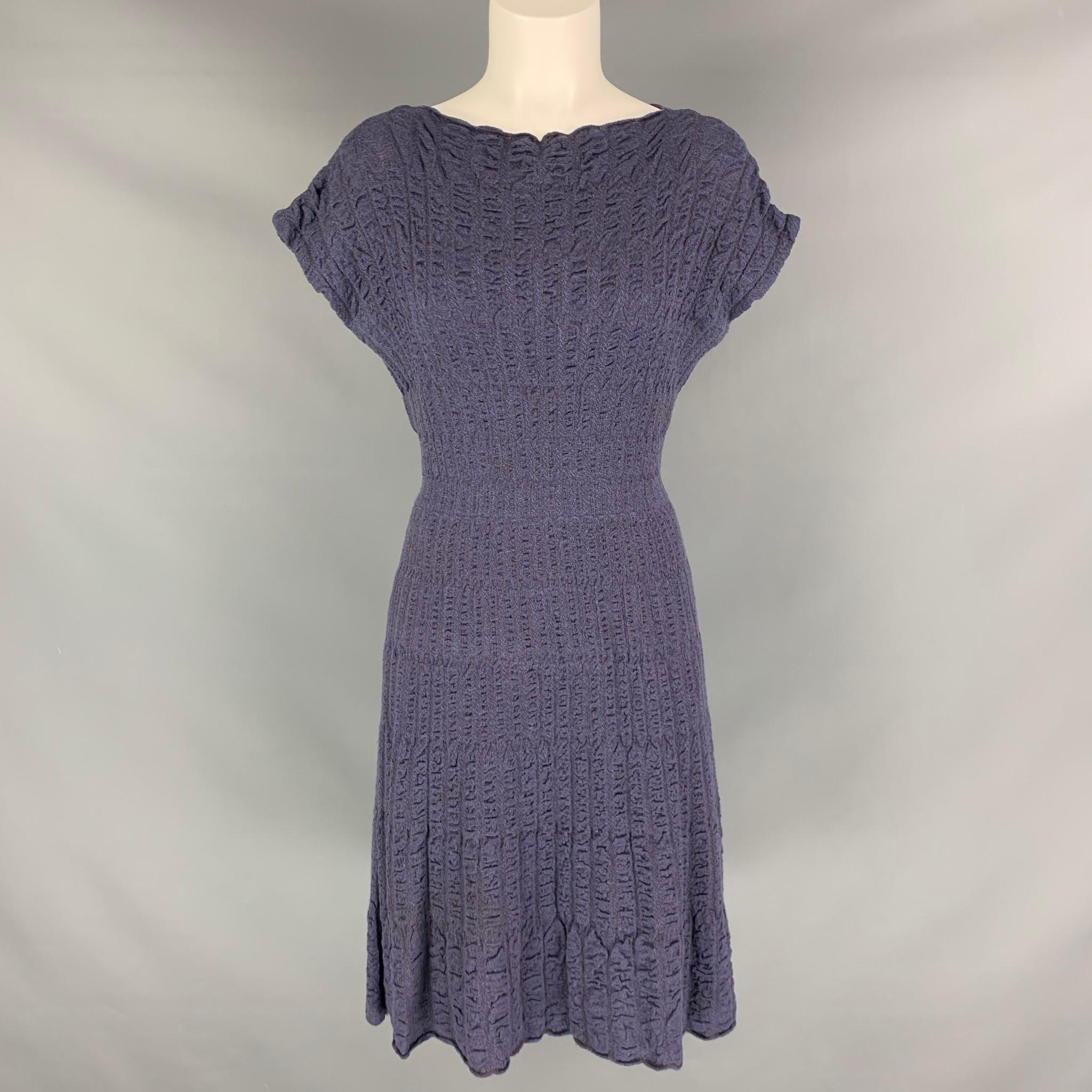 MISSONI dress comes in a purple merino wool blend knit material featuring an A-line style, cap sleeves, striped texture. Made in Italy.

Excellent Pre-Owned Condition.
Marked: 44

Measurements:

Shoulder:316 in.
Bust:34 in.
Waist: 26 in.
Hip: 36