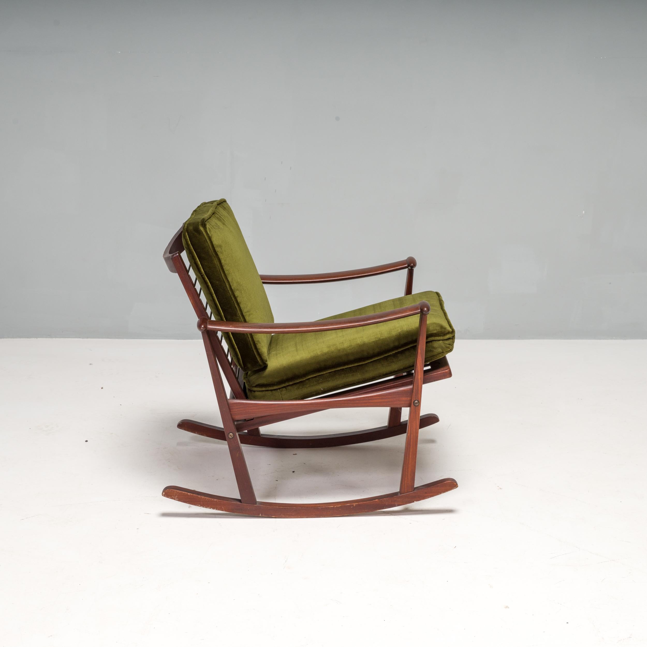 Wooden rocking chair / armchair designed by M. Nissen and sold in the Netherlands by the Dutch manufacturer Pastoe in the 1960s. 

Featuring a solid wooden frame, the chair has curved armrests and a curved base allowing the chair to rock.

The chair