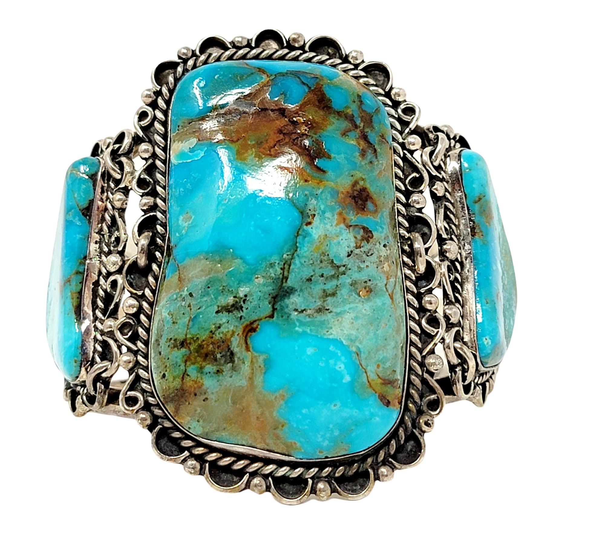 Bold sterling silver and natural turquoise three stone cuff bracelet with detailed metal work. Excellent condition with vintage patina. 

Bracelet type: Cuff
Metal: Sterling Silver
Natural Turquoise: Cabochon
Weight: 113.5 grams
Width: 2.75