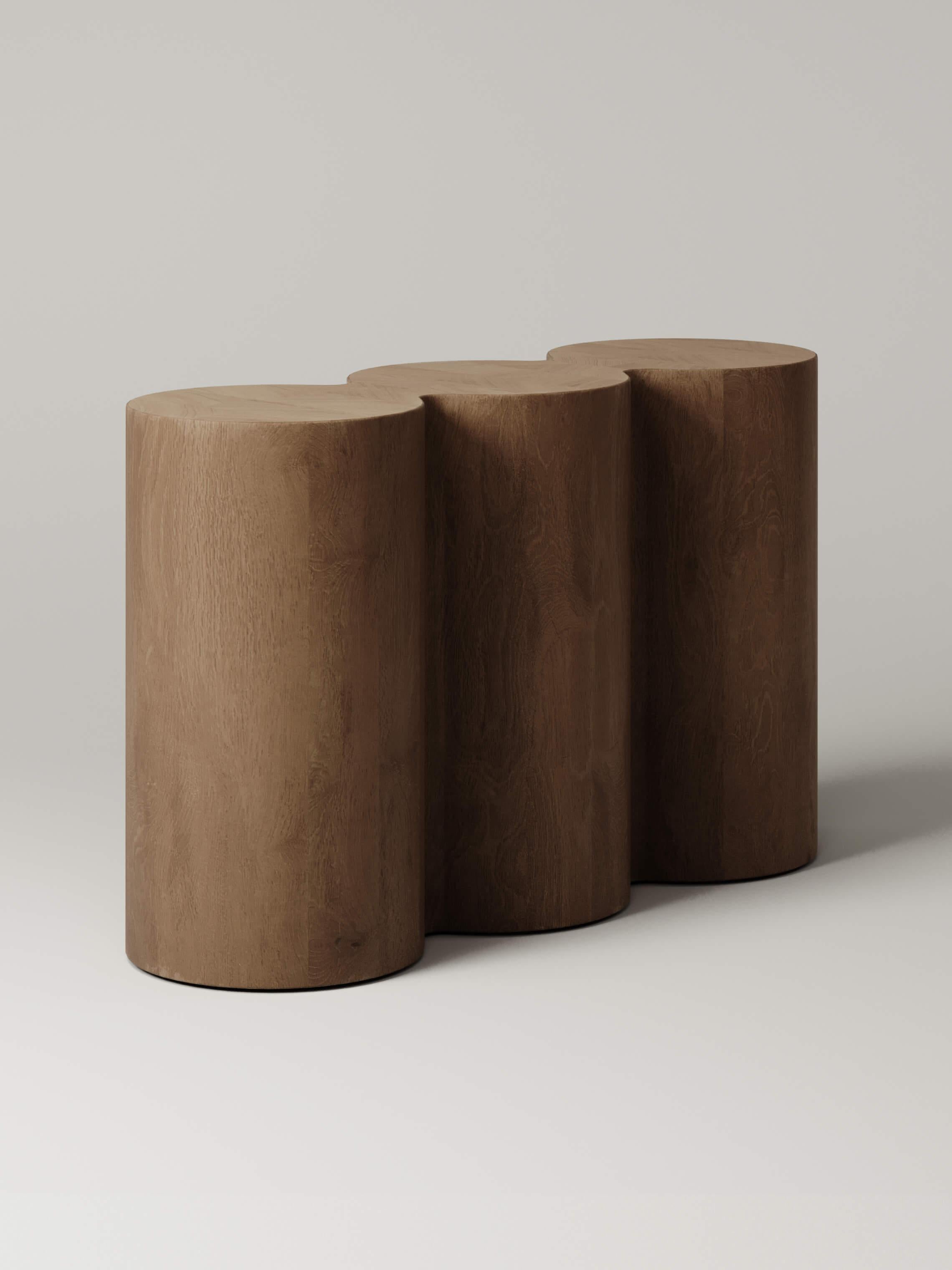 Crafted from oak, the rippled form of the M_008 Console playfully softens the space around it. Part pedestal, part console, it’s sculptural triple column geometry blends the boundaries of utility and form.

Designed by Benni Allan exclusively for