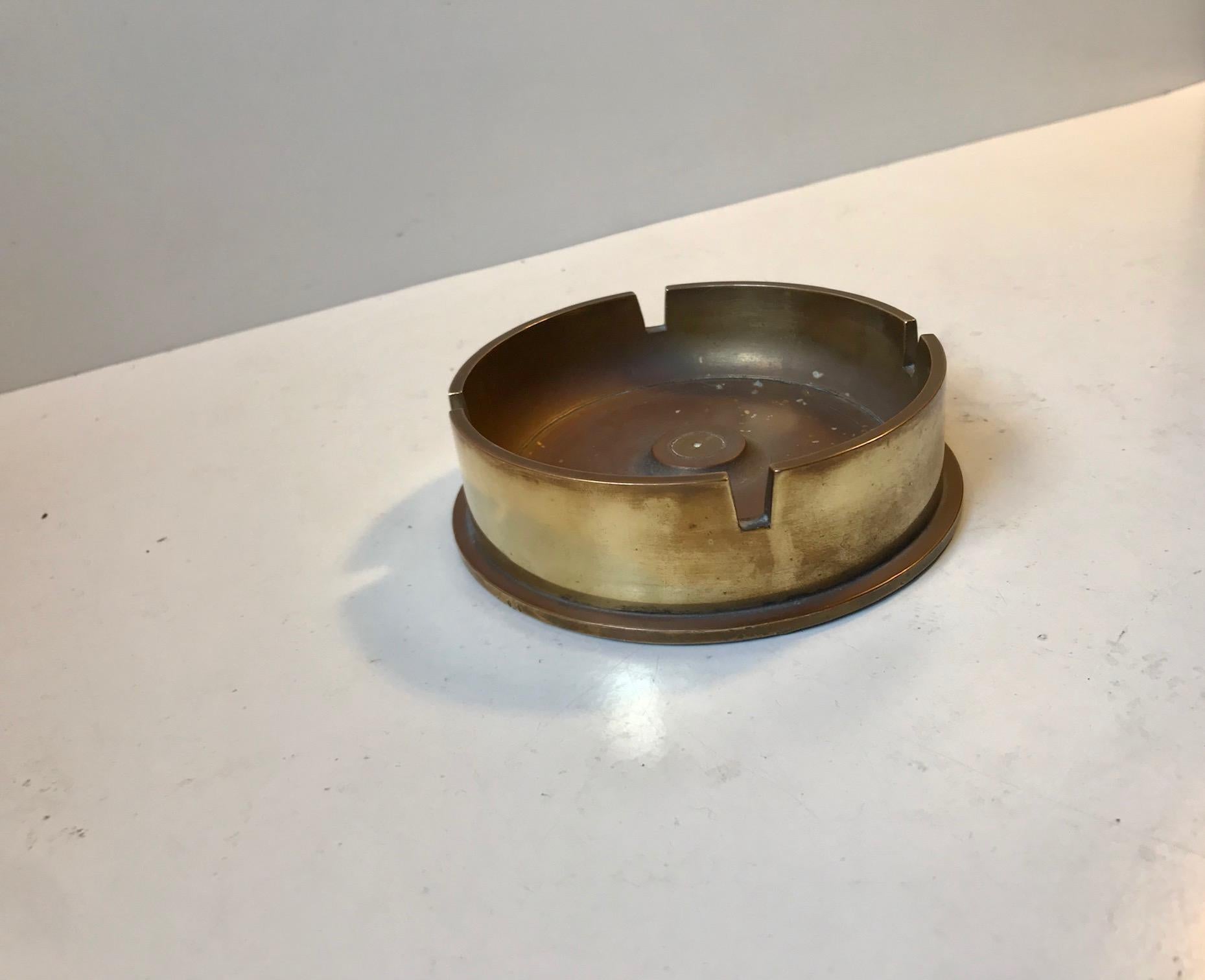 A 105 mm M14 canon shell from 1945 repurposed in to an ashtray. Remodeled in Denmark, circa 1960. It is a heavy thing and the top is made from solid bronze.