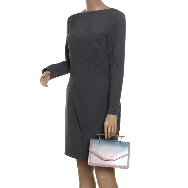 From the house of M2Malletier comes this gorgeous Indre shoulder bag that will perfectly complement all your outfits. It has been luxuriously crafted from patent leather and styled in a mix of blue and peach hues with a front flap and a spacious
