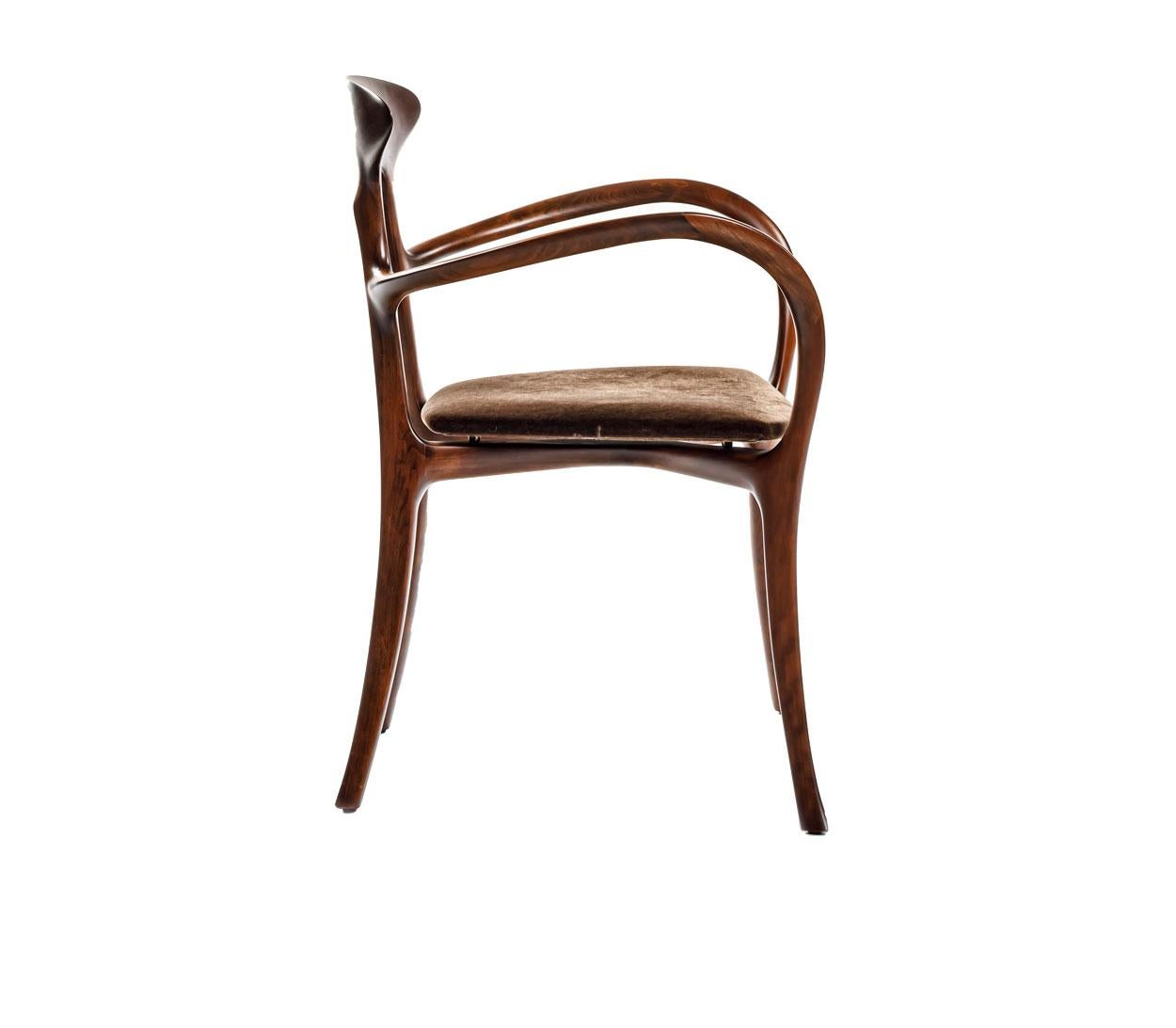 A chair made in solid American walnut wood with a cherrywood stain and semi-gloss finish, curved plywood seat upholstered in dark brown velvet. 
by Roberto Lazzeroni for Ceccotti Collezioni.