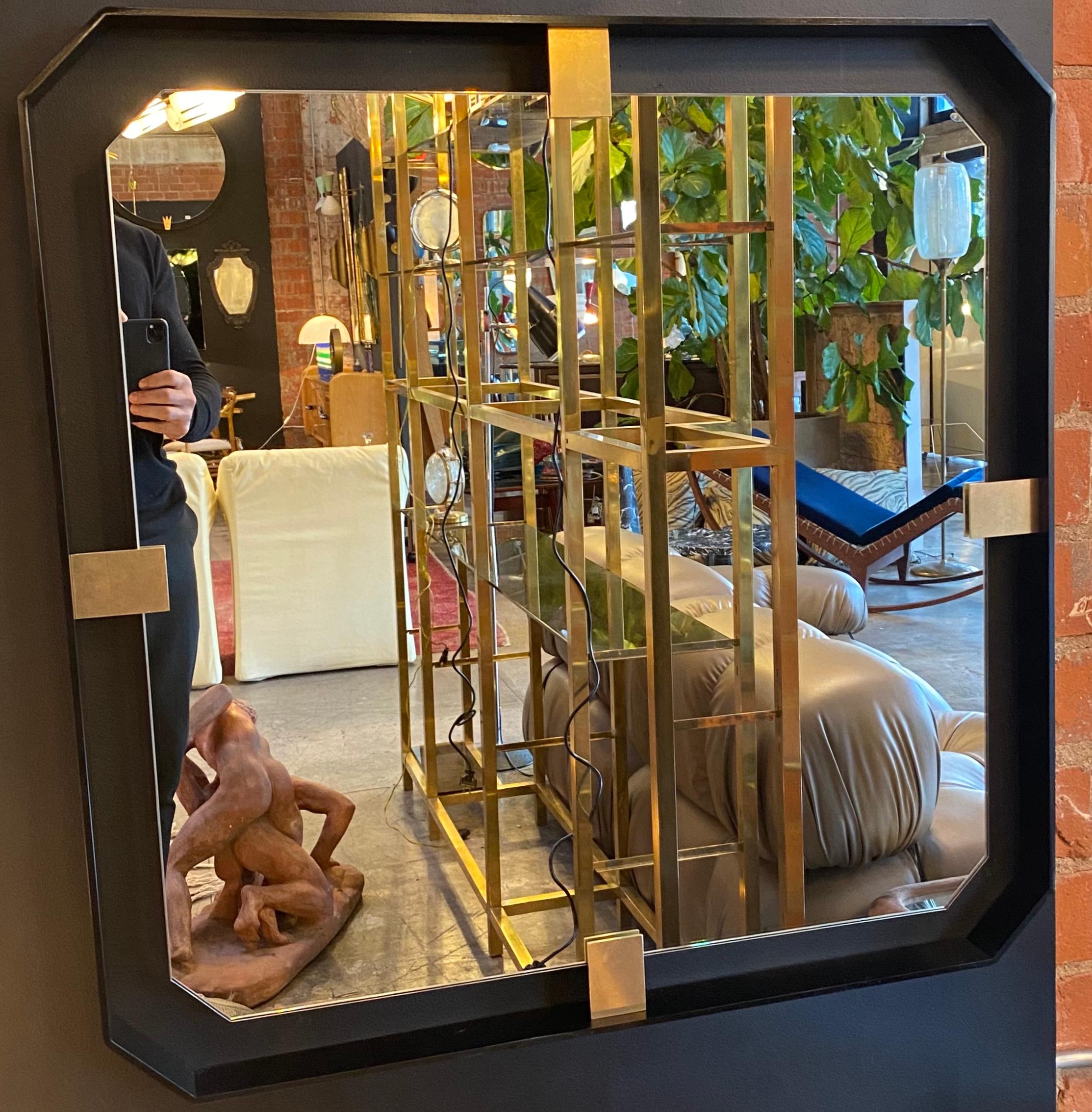 Square in dark iron, floating-style frame that accentuates the shape and height of this mirror and details in brass.
Place of origin: Italy
Condition: Excellent. Perfetto.