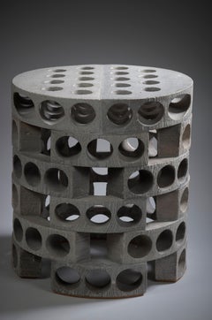 Architectural stoneware round stool with large openings by Maarten Stuer