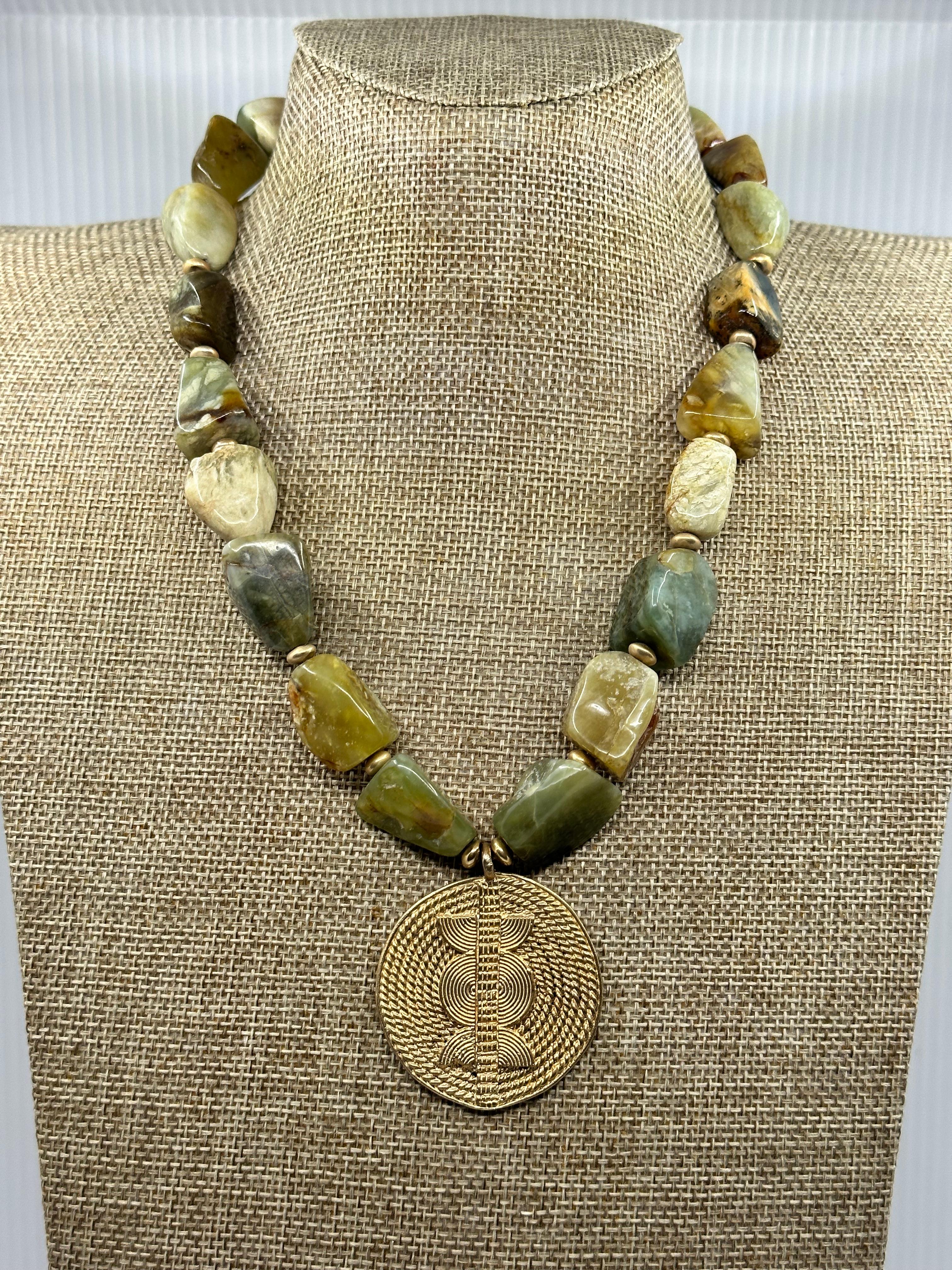 Magnificent Maasai Moss Agate Necklace with a wonderful 14K Yellow Gold medallion. Breathtaking is the only word that we can use to describe the authentic representation of the noble Maasai tribe in this one of a kind necklace by award winning