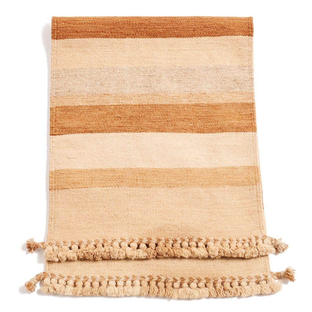 MAATI  is beautiful stripes  design handloom rug, handwoven by a heritage artisan family and one of the last few of its kind in the community. These master weavers are based in a small village in India with whom Studio variously exclusively