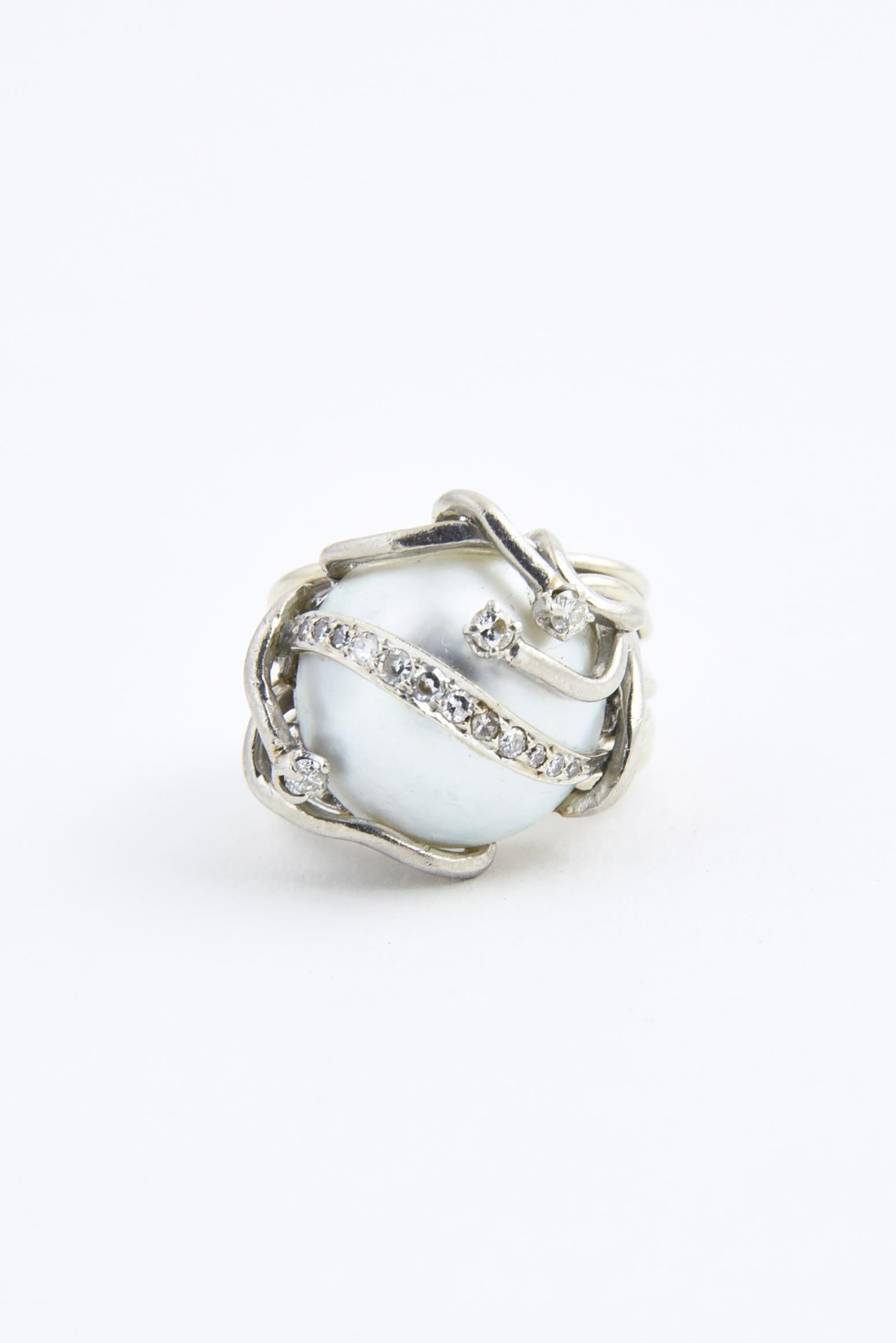 1960s freeform ring featuring a mabe blister pearl mounted in a 14K white gold wire design with diamonds. Marked: 14K. US size: 6 - 6.25.

This ring can not be sized.
