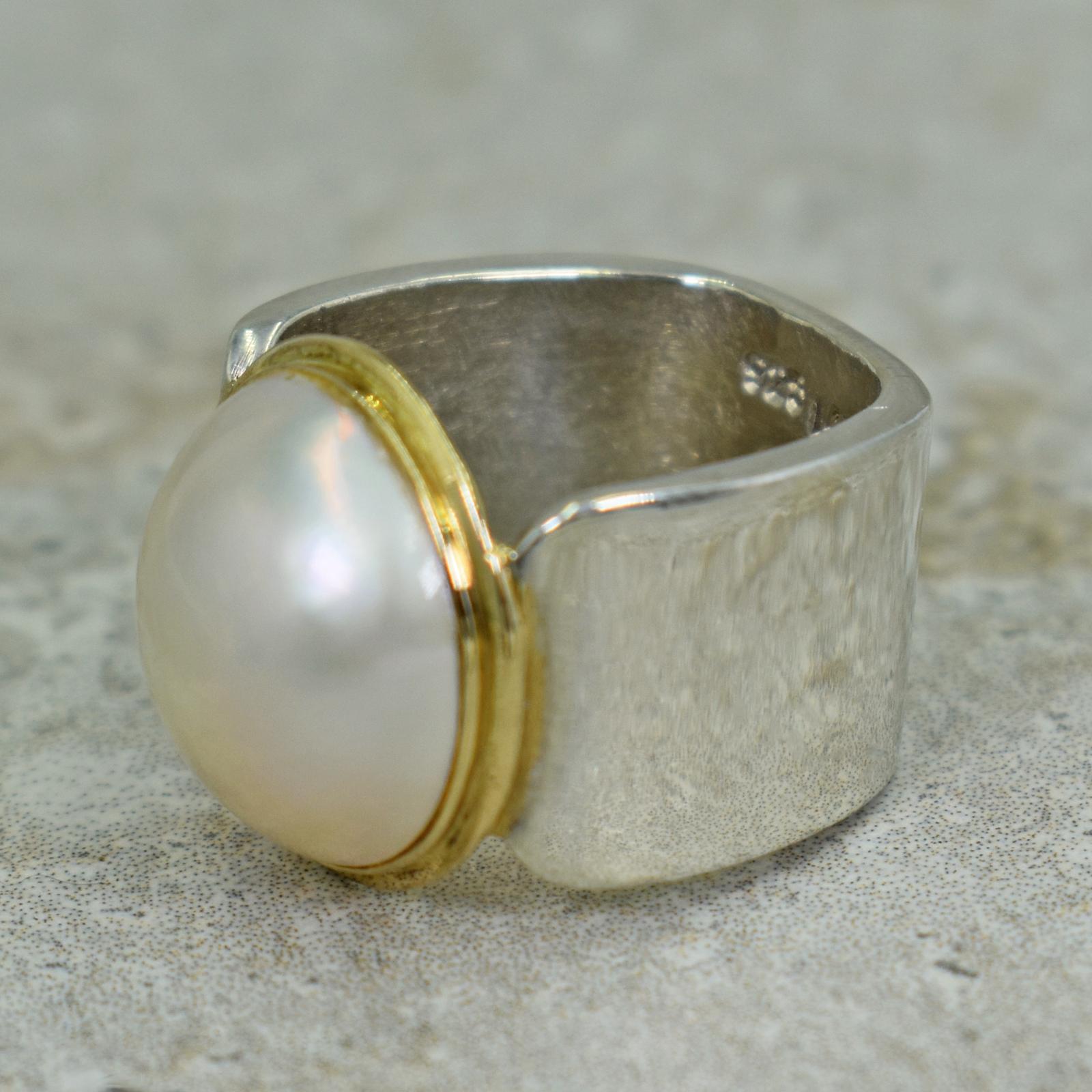 Mabé Freshwater Pearl set in a 14k yellow gold bezel on a sterling silver square ring band. Size 5. Ring is stamped 925, 14k and VO. Beautiful, classic pearl in a fresh, contemporary two-tone setting.