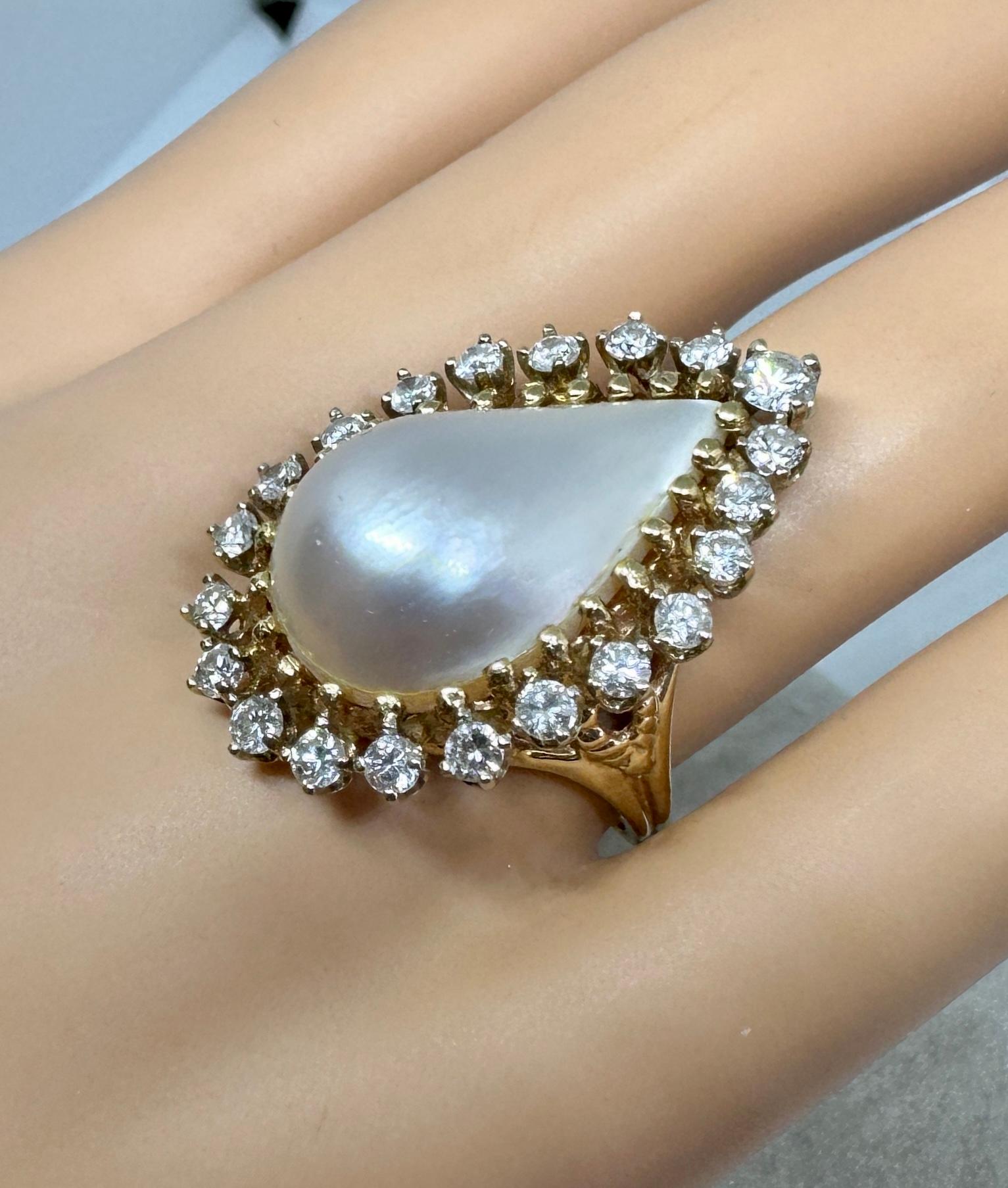 This is a gorgeous Mabe Pearl Cocktail Fashion Ring with a Halo of 21 Diamonds totaling approximately 2 Carats in 14 Karat Yellow and White Gold.  The ring is a Diamond and Pearl extravaganza at its most dramatic!  In the center is a magnificent