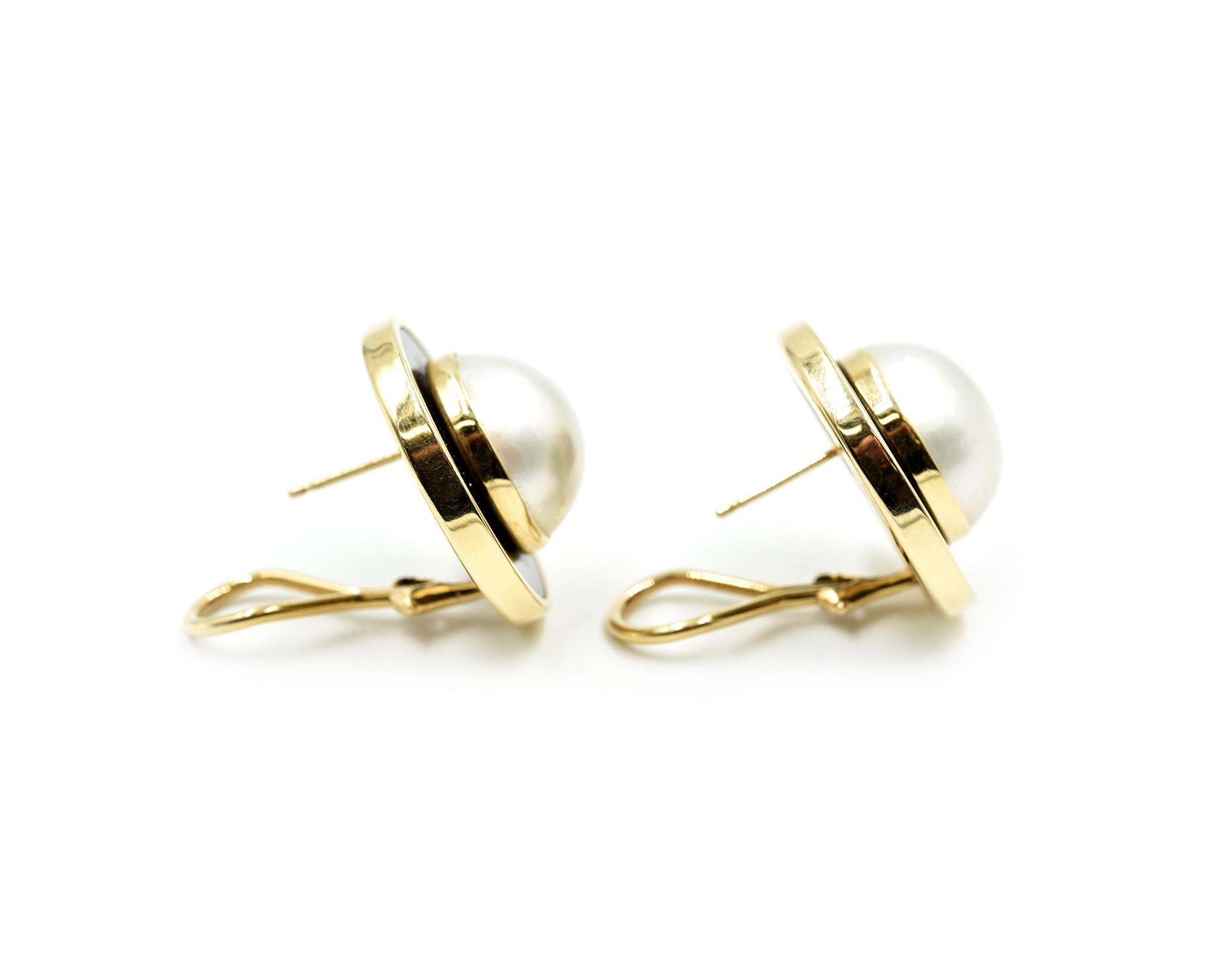 Designer: custom design
Material: 14k yellow gold and black onyx
Pearls: two 15mm mabe pearls with silver overtone
Fastenings: omega backs
Dimensions: each earring is 7/8-inch in diameter 
Weight: 13.02 grams
