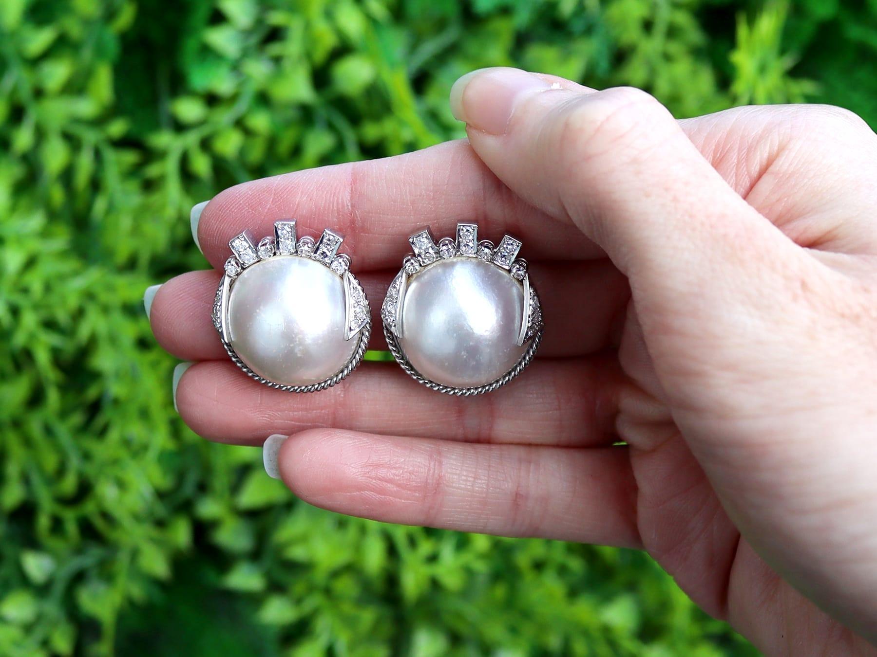 A stunning pair of mabe pearl and 0.78 carat (total) earrings in the Art Deco style in 9 karat white gold; part of our diverse jewelry and estate jewelry collections.

These impressive earrings have been crafted in 9k white gold.

Each earring