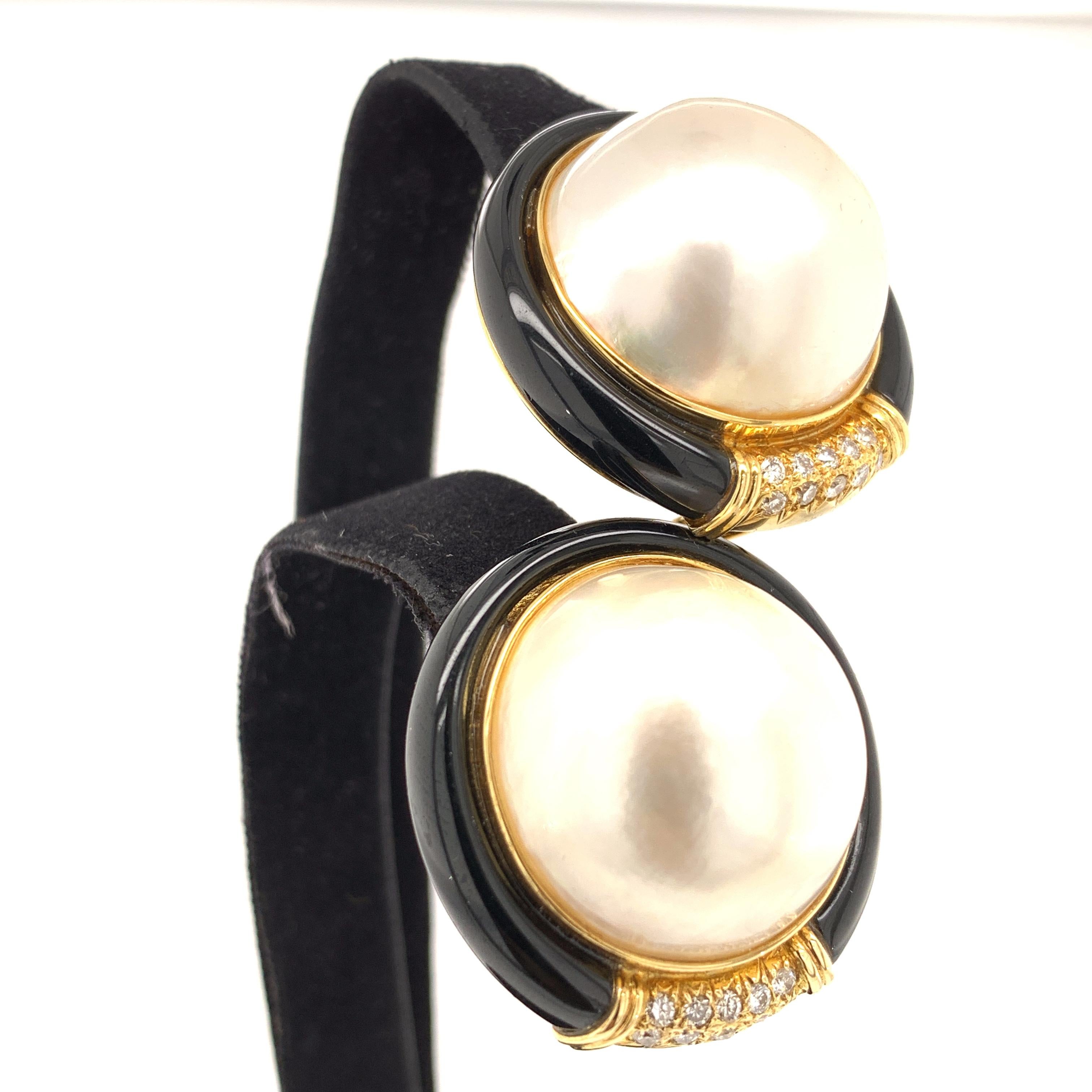 Mabe Pearl, Black Jade, and White Diamond Gold Earrings:

A beautiful and elegant pair of earrings, it features a pair of large Mabe pearls surrounded by black jade and white diamonds. The Mabe pearls are of fine quality with great lustre and