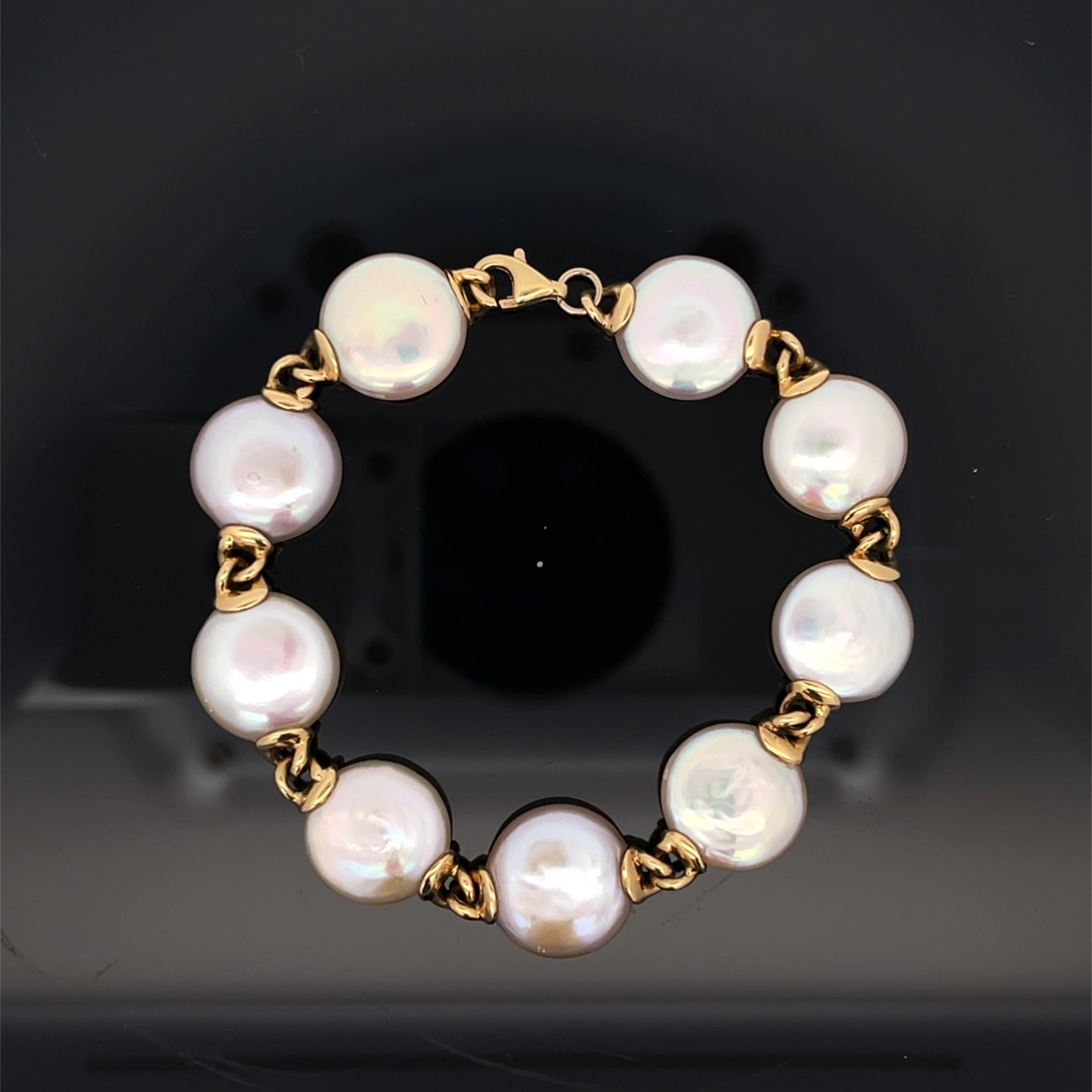18K Yellow Gold Bracelet Length 7 inch With 9 Mabe Pearls. The mabe pearls are approximately 13mm wide, and the bracelet weighs 21 grams.