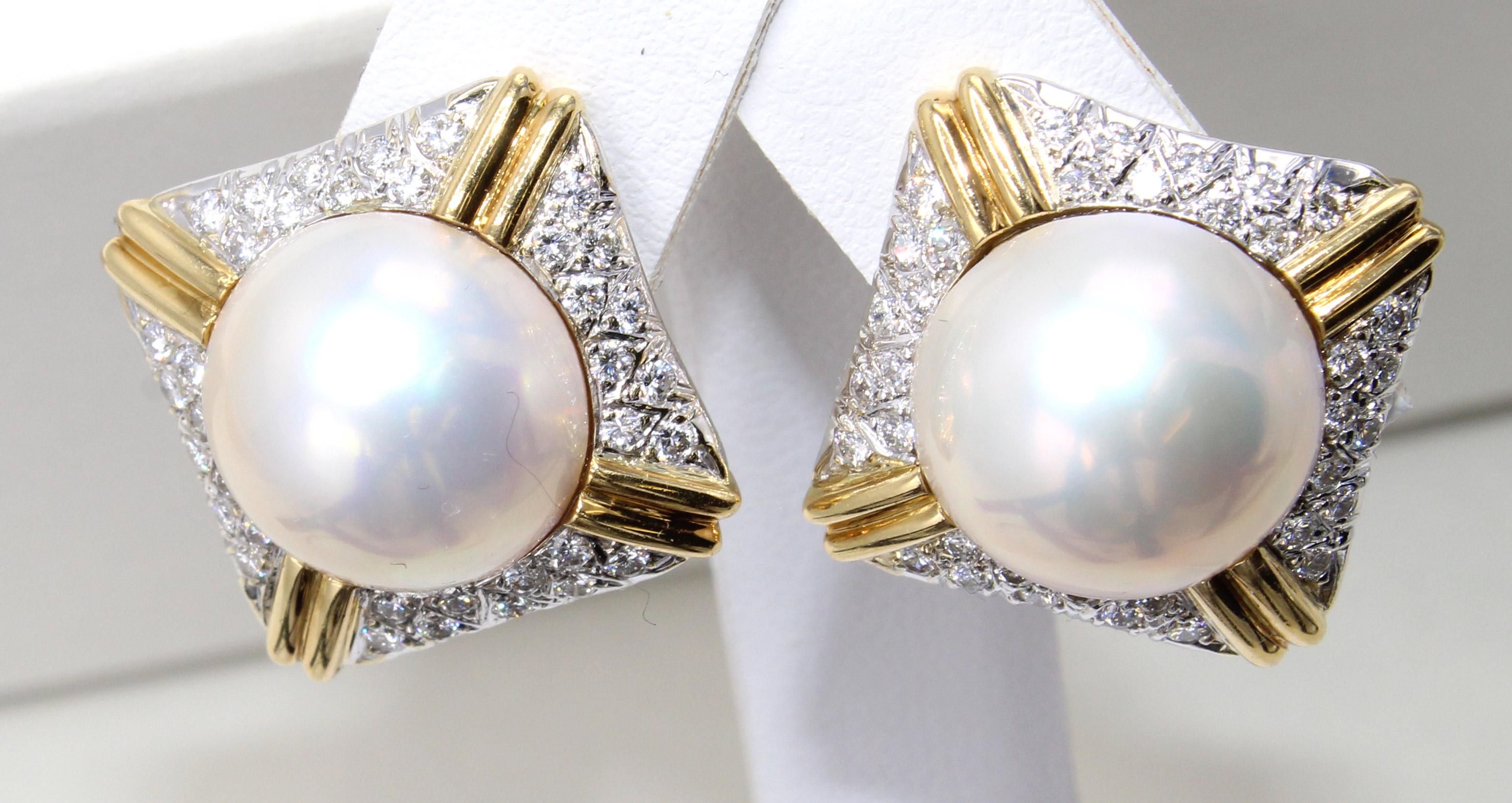2 perfectly matched white lustrous 13 millimeter mabe pearls are the center piece of these well hand-made 18 karat gold diamond earrings. 36 bright white lively round brilliant cut diamonds set in each earring create a wonderful sparkle on the ear.