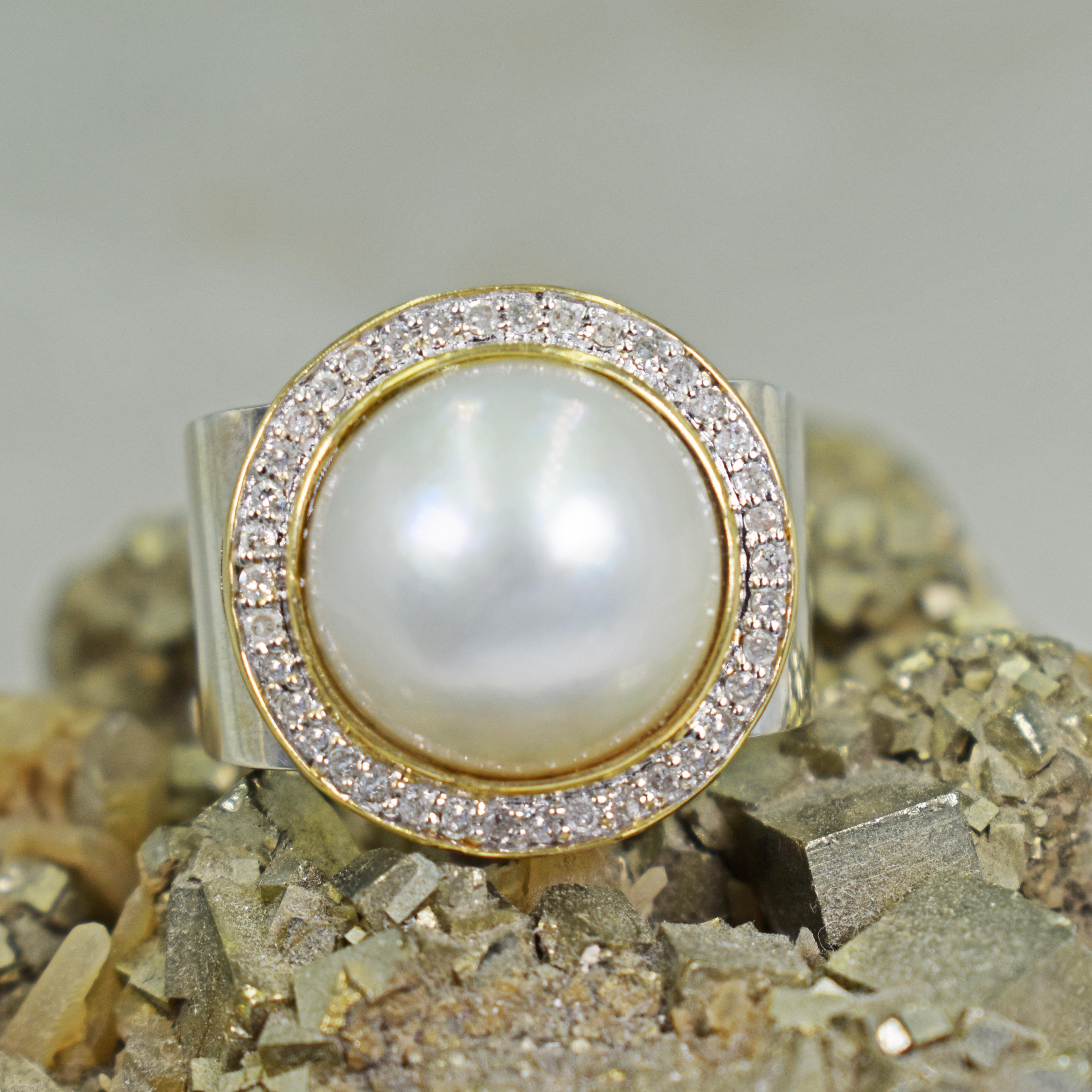 Beautiful, white Mabe Pearl set in 14k yellow gold and diamond halo on a square, tapered sterling silver ring band. Size 7. Base of ring band is 0.38 inch wide, and top of ring band is 0.50 inch wide. Pearl halo 14k gold top measures 0.75 inch in