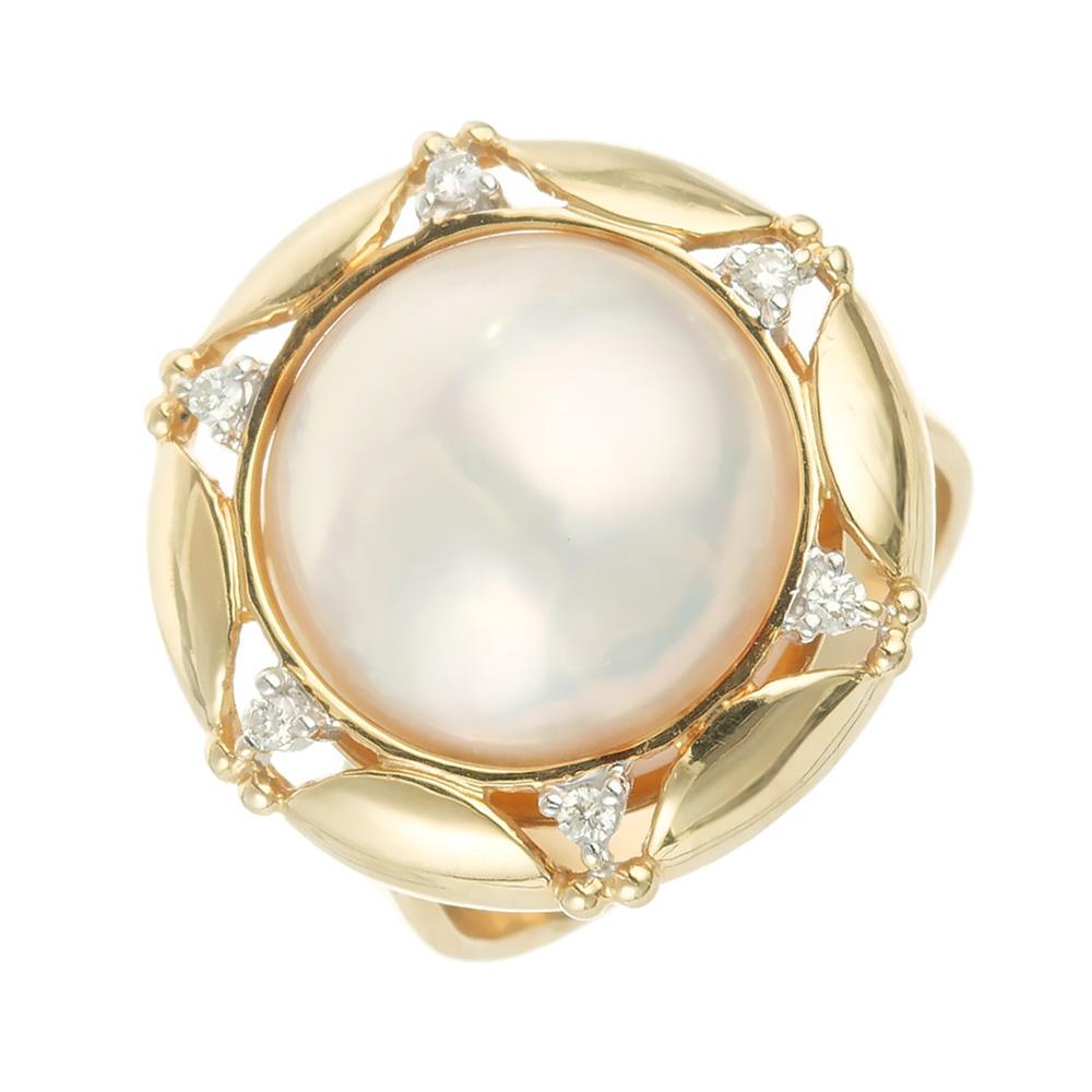 1970's 15mm Mabe Pearl 14k yellow gold cocktail ring. One white cultured large Mabe pearl with a halo of 6 round full cut diamonds.  

1 white cultured Mabe pearl, 15mm, high lustre
6 round full cut diamonds, approx. total weight .12cts, H, SI
Size