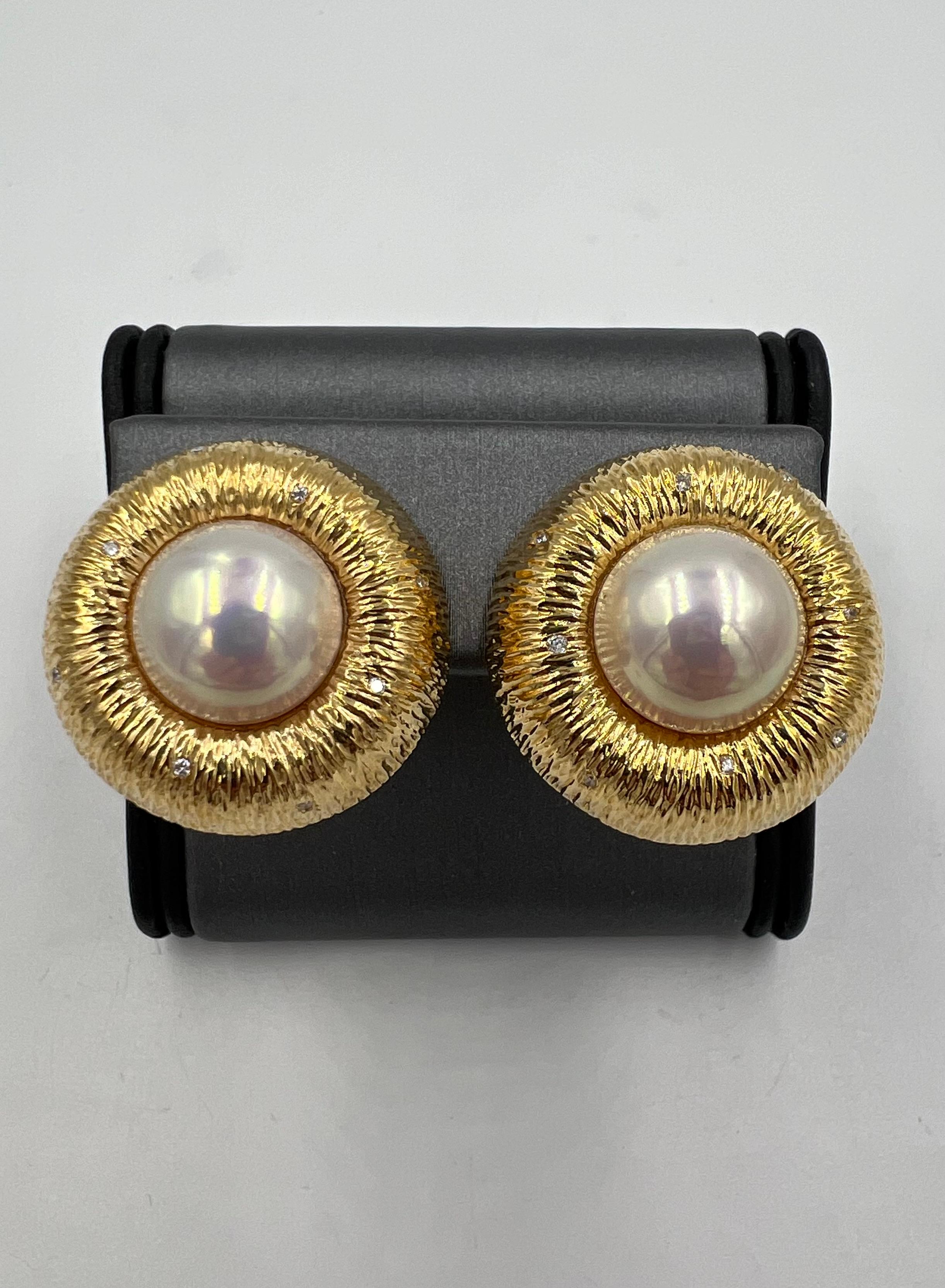 Mabe Pearl diamond 18k yellow gold earrings, ca 1990s.
The Mabe pearl diamond yellow gold earrings from the 1990s make a bold statement.  These earrings feature lustrous Mabe pearls surrounded by textured yellow gold. And to add a touch of sparkle,