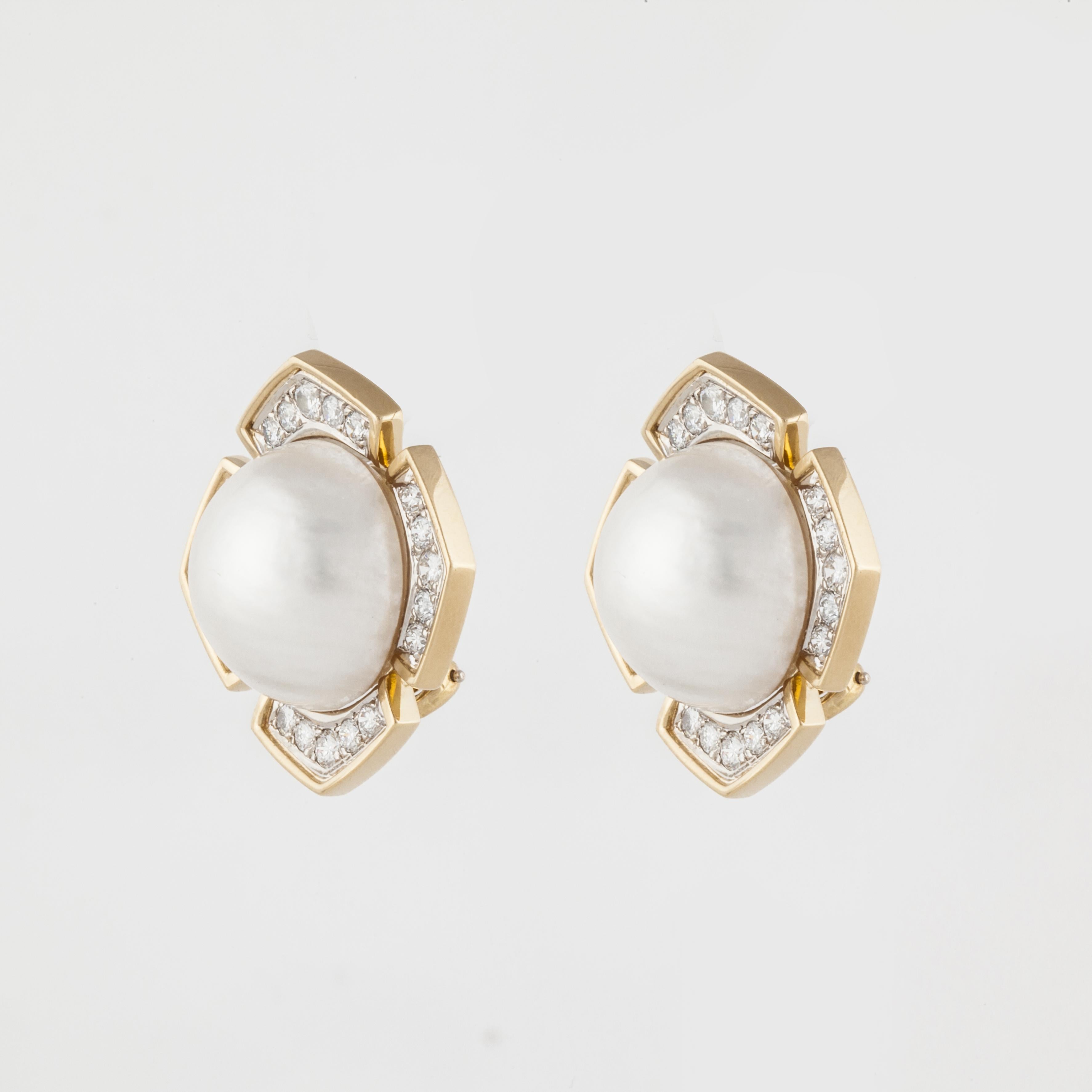 18K yellow gold earrings featuring mabé pearls accented by round diamonds.  The pearls measuring 17-17.5mm.  There are 40 round diamonds weighing 2.10 carats; G-H color and VS1-VS2 clarity.  Measure 1 1/8 inches across.  These are clip style