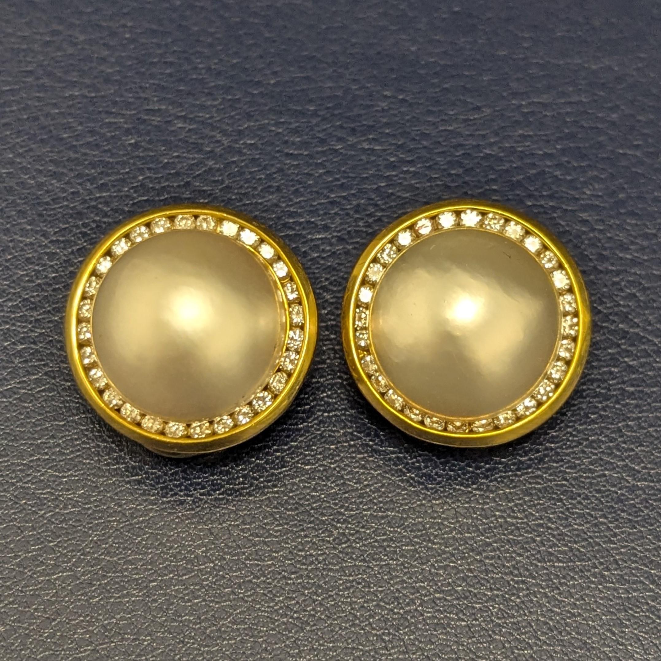 These earrings feature slightly creamy mabé pearls, delicately surrounded by 56 round diamonds and set in yellow gold with clip-back closures.