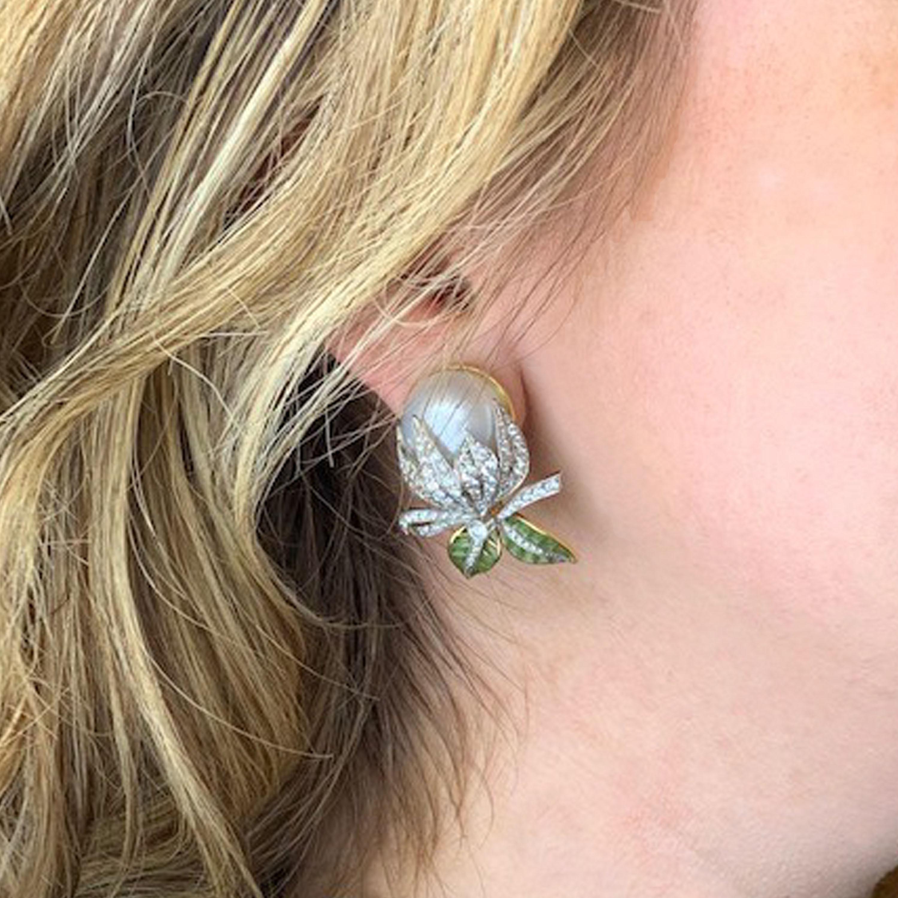 A pair of Moira bud earrings, with mabé pearls, measuring approximately 16mm, with pavé set round brilliant-cut diamonds and green plique à jour enamel leaves, mounted in gold, with white gold settings. Signed and numbered. Moira's eponymous