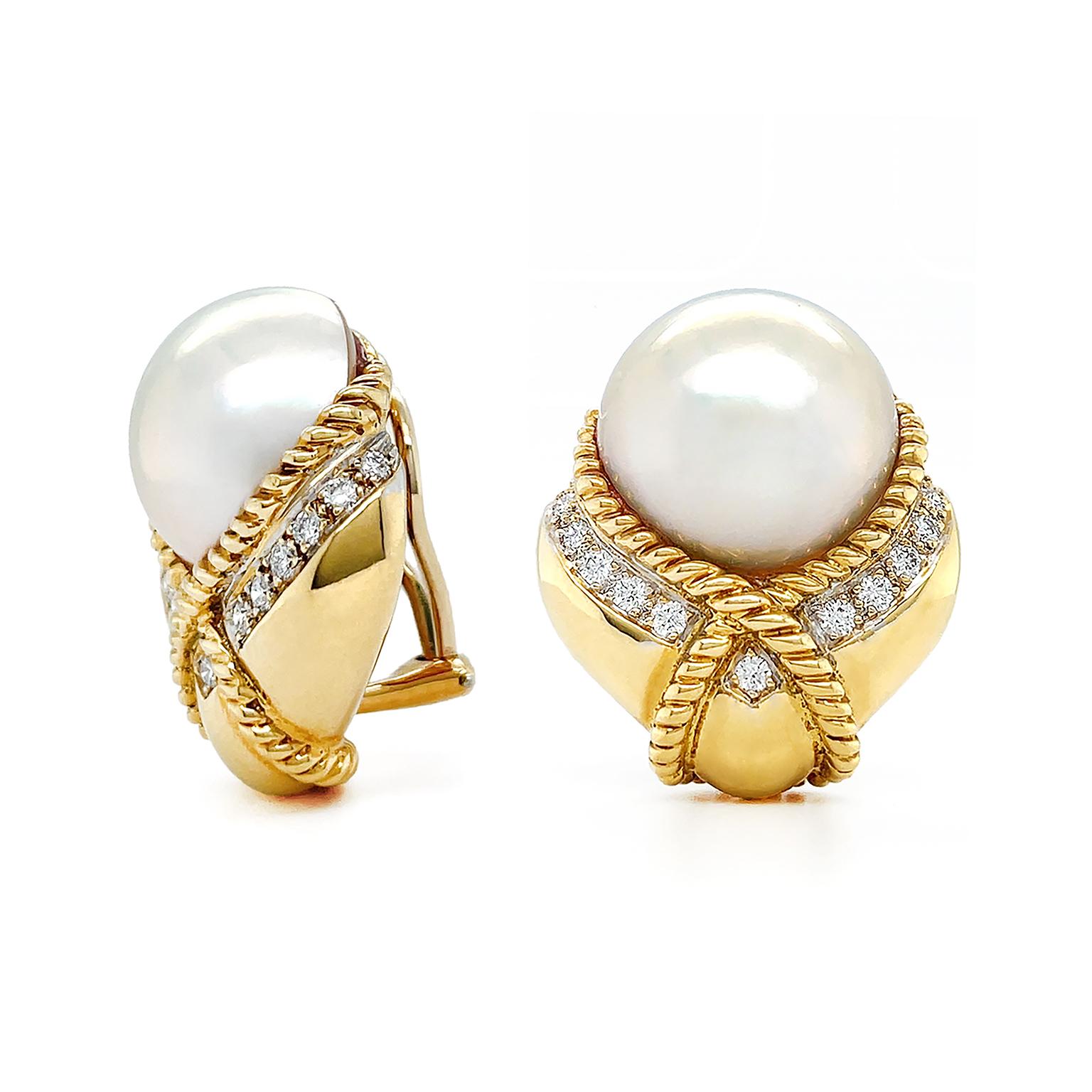 Sleek tapering 18k yellow gold is enriched by brilliant cut diamonds as the foundation of these earrings. A single mabe pearl, reflecting a luminous array of soft purple, green and blue hues, sits in the center. Embracing the edge of the pearl is a