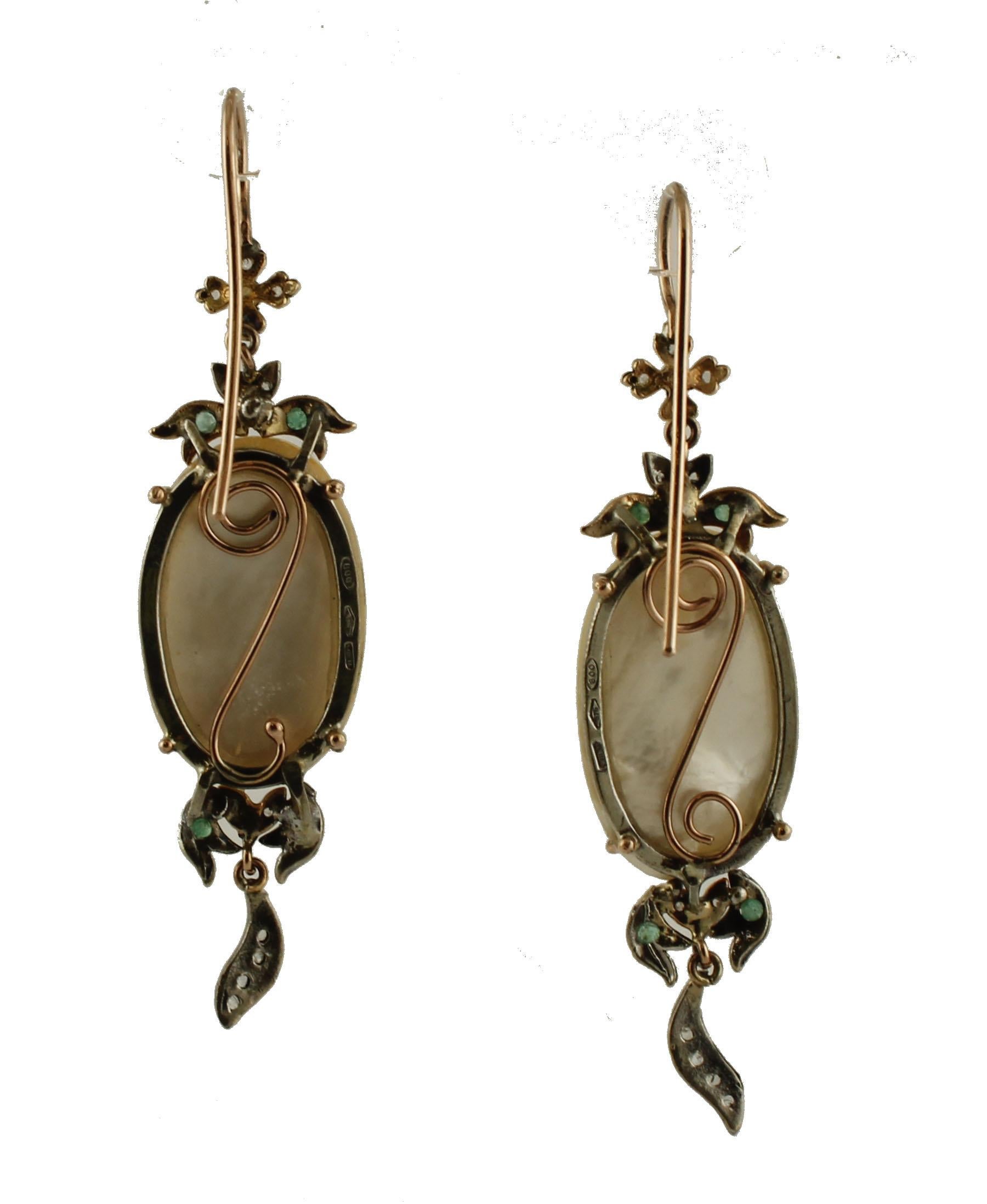 Unique pair of dangle earrings in 9k rose gold and silver structure, realized with 2 central Mabe pearls, adorned by flowery details in the upper part and at the bottom. 
These earrings are totally handmade by Italian master goldsmiths
Diamonds 0.13