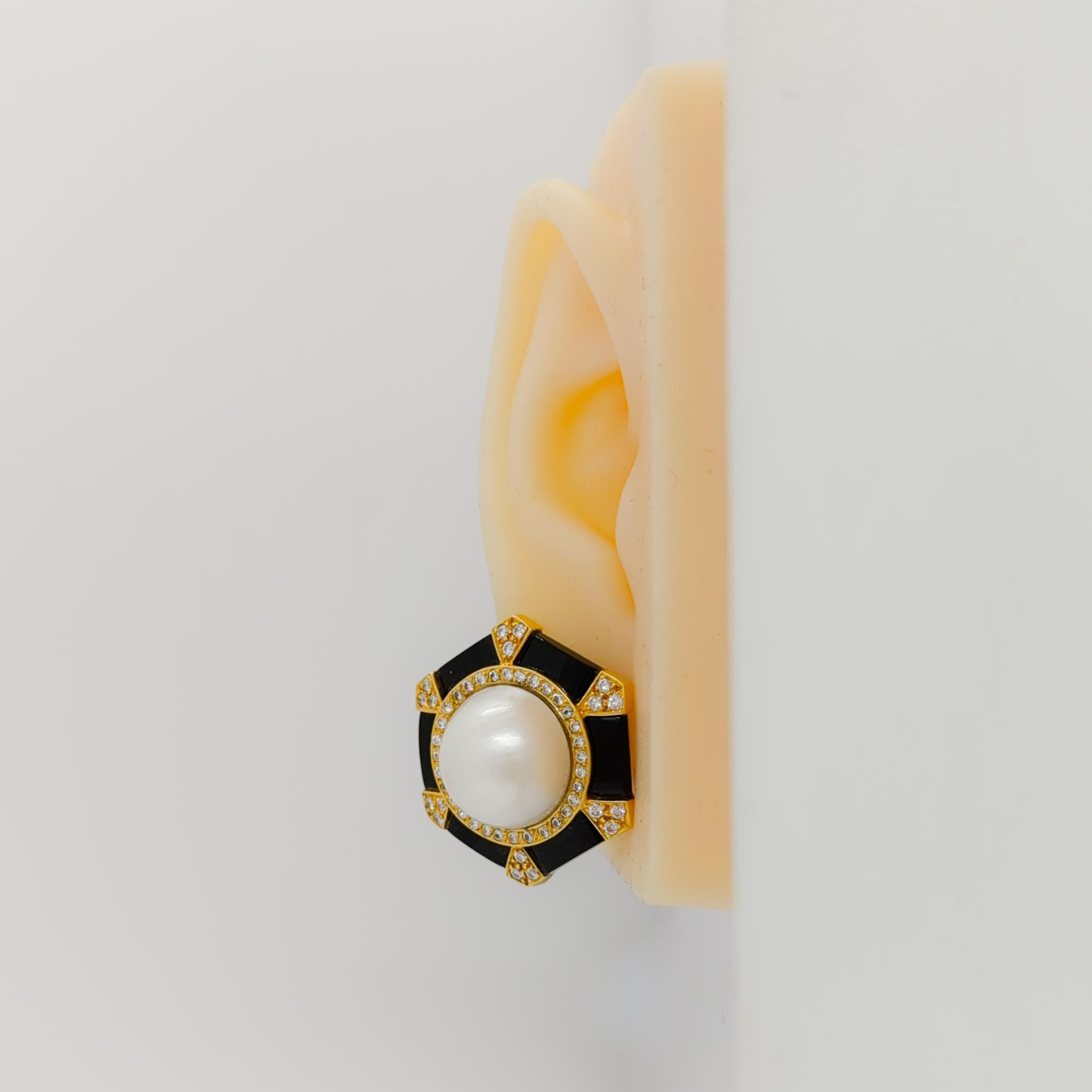 Beautiful onyx, mabe white pearl and 1.00 ct. white diamond round earrings handmade in 18k yellow gold.  A great addition to any fine jewelry collection.  Clip on earrings.