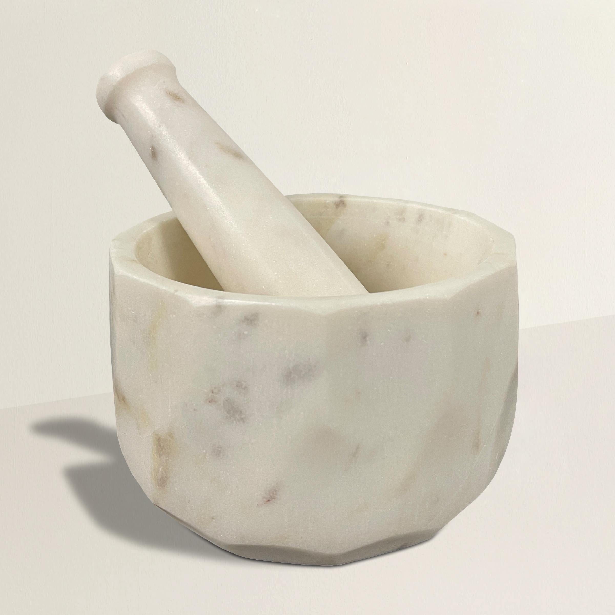 A chic modern-in-spirit faceted marble mortar with a marble pestle, large enough to crush even the largest of spices, but small enough to keep on your kitchen counter and filled with salt or pepper to it's always on hand.