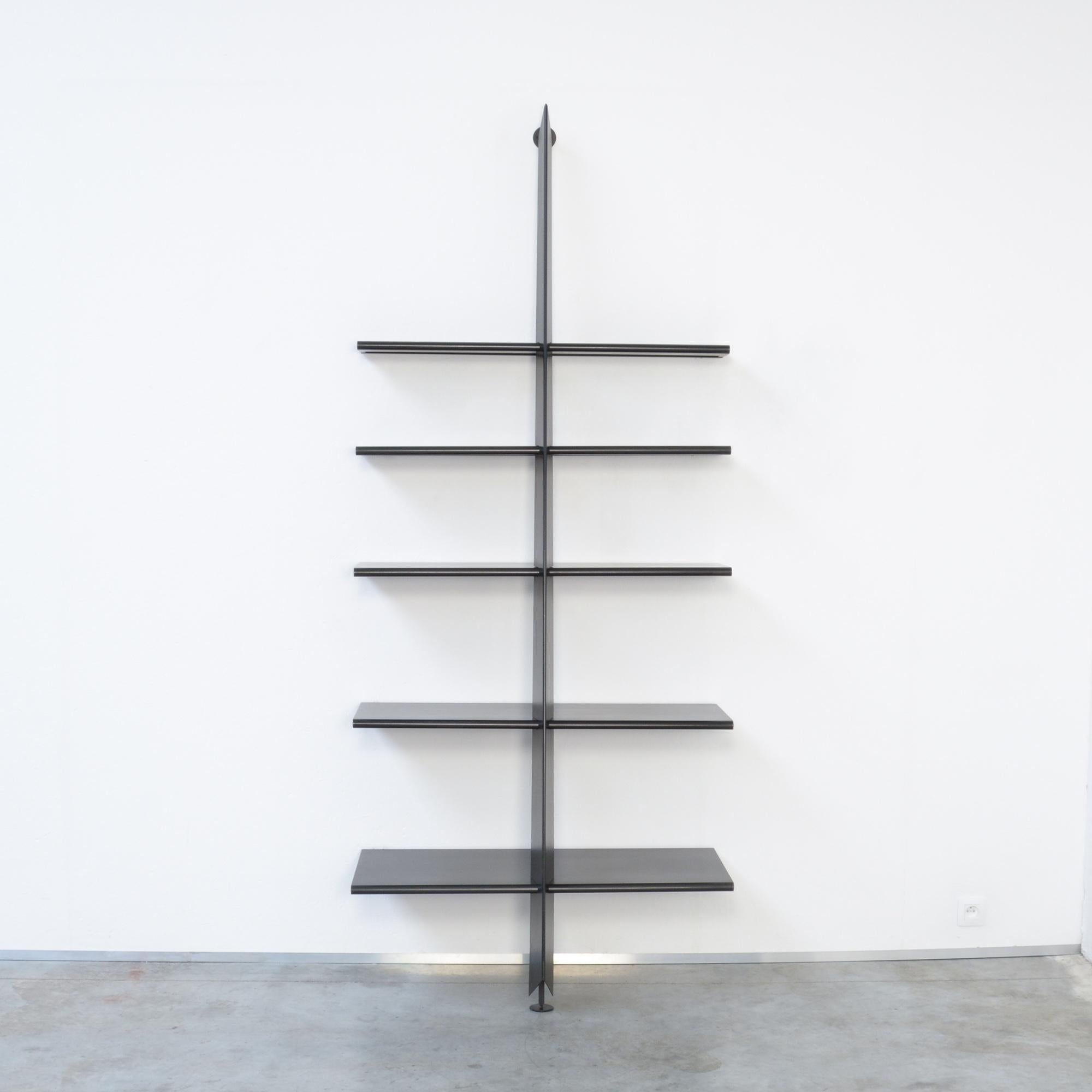 Mac Gee is a book shelf designed by Philippe Starck, it was made in cooperation with Baleri Italia in 1984 in the beginning of Starcks career.
This Mac Gee book shelf is made of black metal. The central pillar has to be fixed on the wall. The five