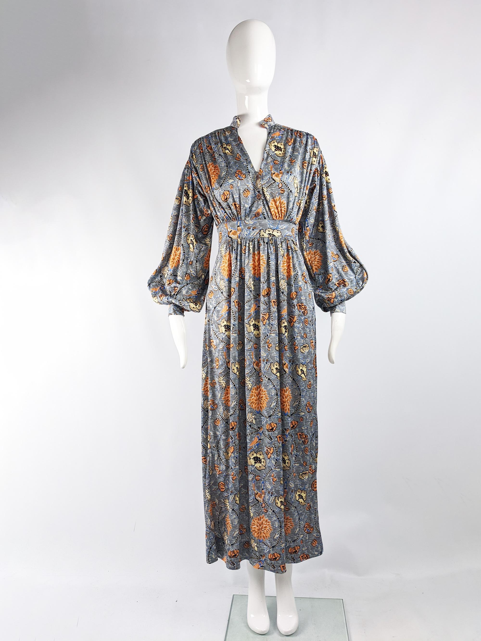 A fabulous vintage boho full length maxi dress from the 70s by Parisian label, Mac Tac. In a grey, floral printed ban-lon jersey which has incredible drape. It has beautiful soft pleats and huge balloon sleeves. 

Size: Marked vintage 38 but fits