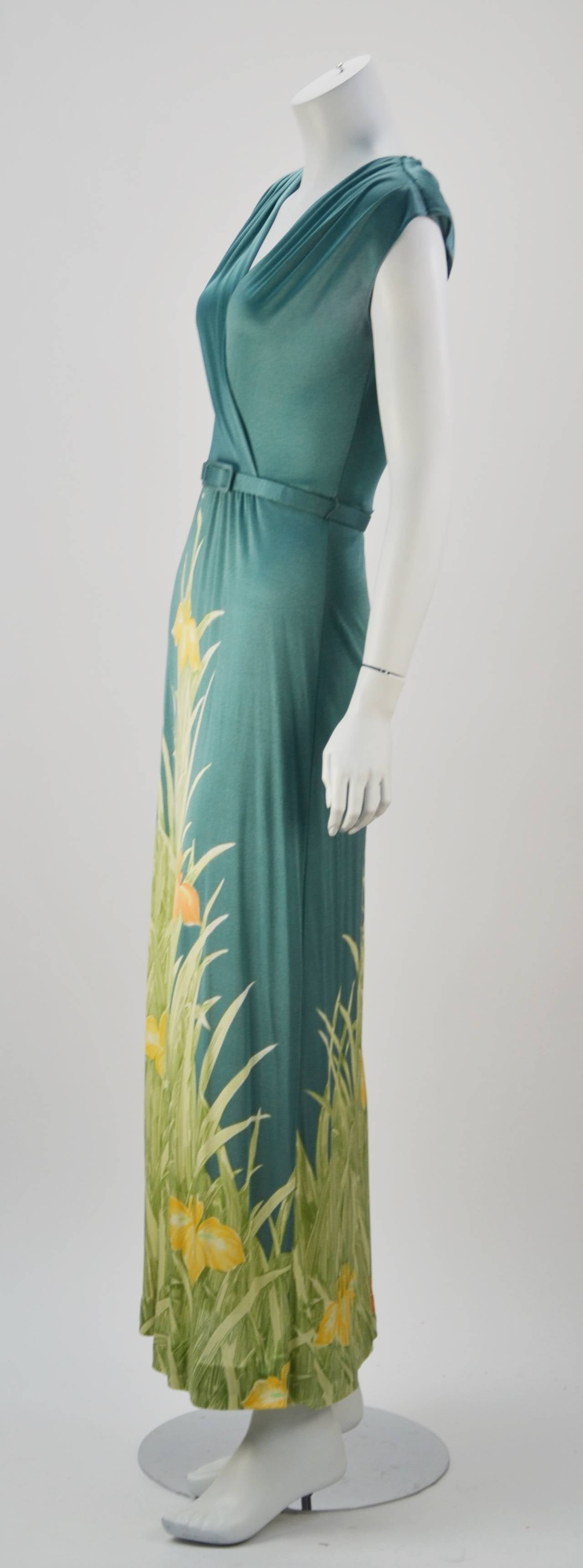 Spring is here in this Leonard Sunshine dress. Flattering, fits like a glove with stretch, and comfortable too!  Louisiana iris print is placed strategically on the skirt and also accents the belt. The flowers are orange and yellow against green