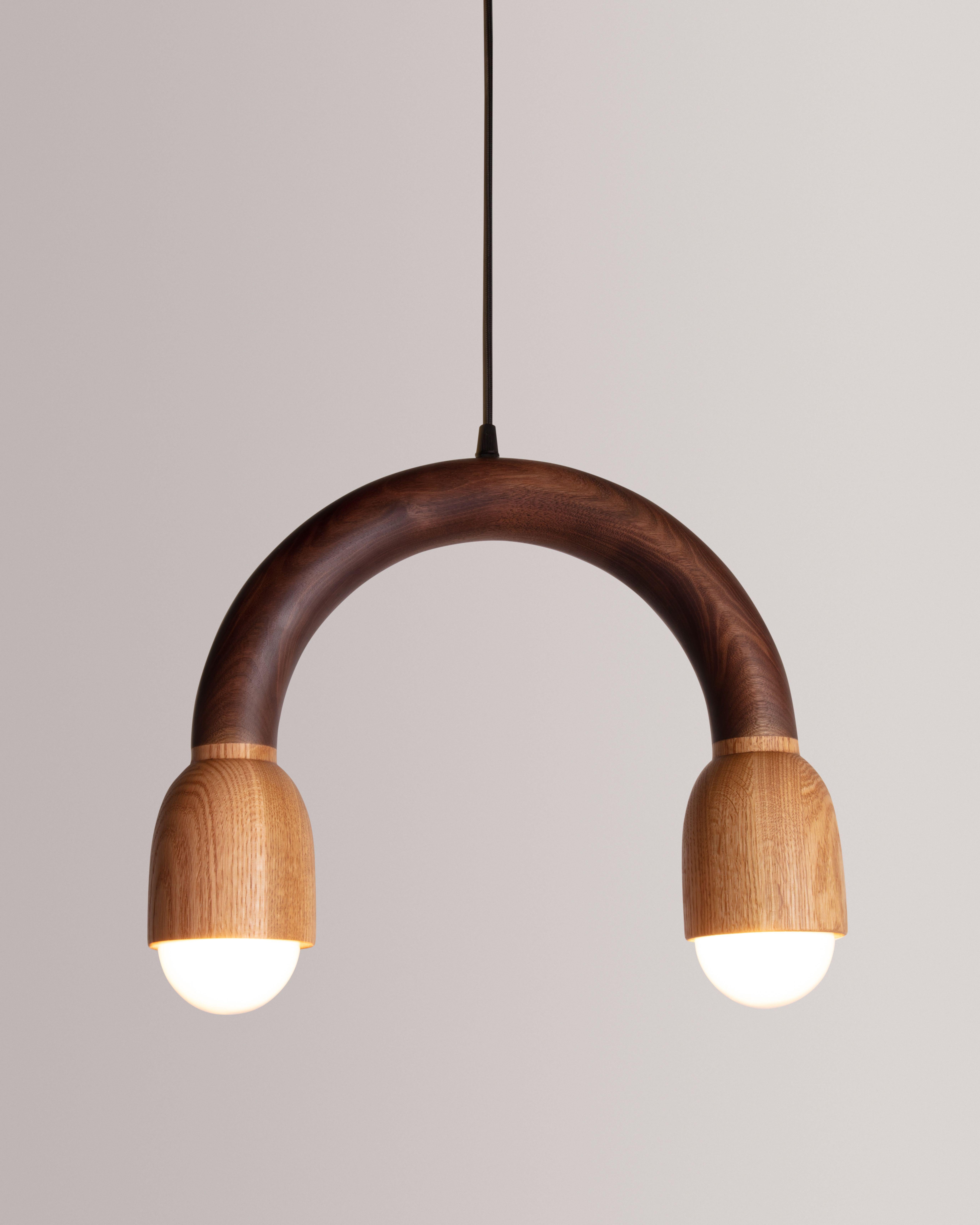 The Macaroni Light was created though an exploration of shaping solid walnut slab lumber. Designed to bring a smile to any space, each light is thoughtfully selected to highlight the grain pattern and characteristics of American black walnut. Each