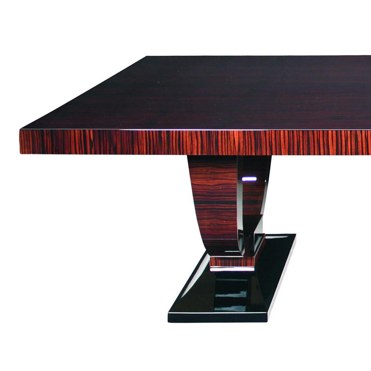 Grande Art Deco table in Macassar ebony with black high gloss accent details on the quintessential Deco base, inspired by Ruhlmann design.
Available with or without the center brace. Extension leaves can be added on ends in matching veneer or black