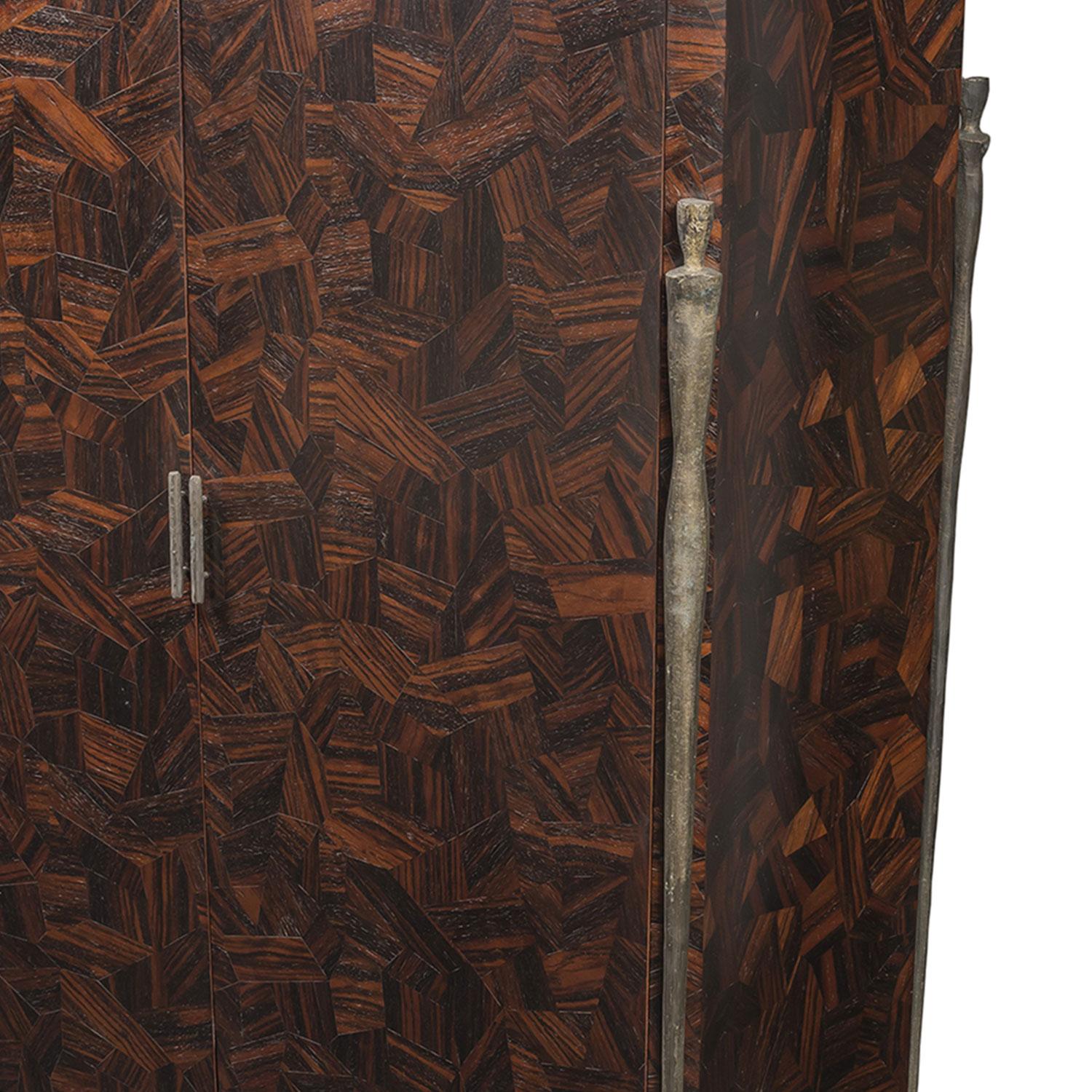 Macassar ebony parquetry, bronze hardware, concave door fronts and curved granite top come together to form the Cabinet Bruck. Long bronze Giacometti-inspired pier legs adorn the four corners with matching bronze cabinet pulls on the inward-curving