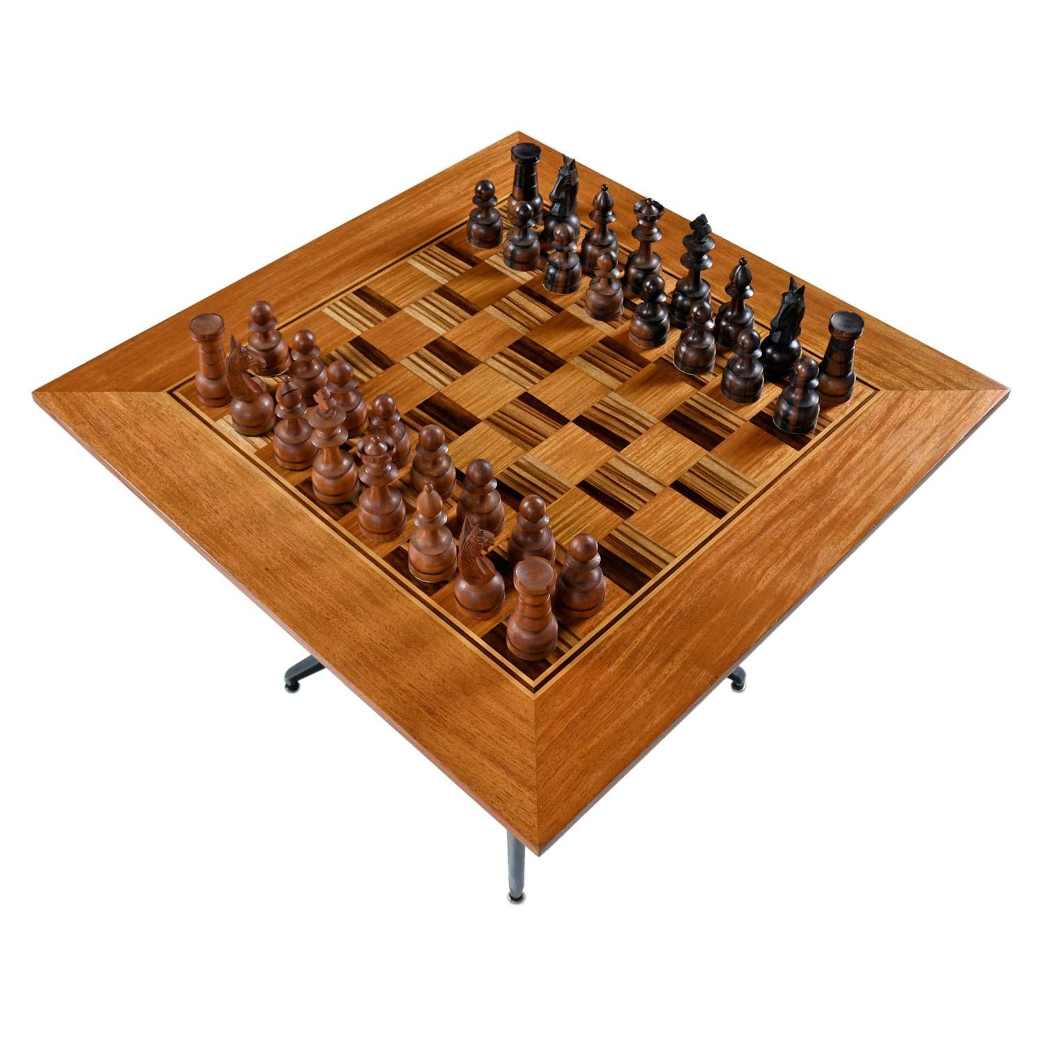 This spectacular chess table set is one of a kind. The game board is a magnificent creation of checkerboard pattern Macassar ebony and teak wood. The striped ebony is absolutely stunning and is tempered by the honey colored teak. The perimeter of