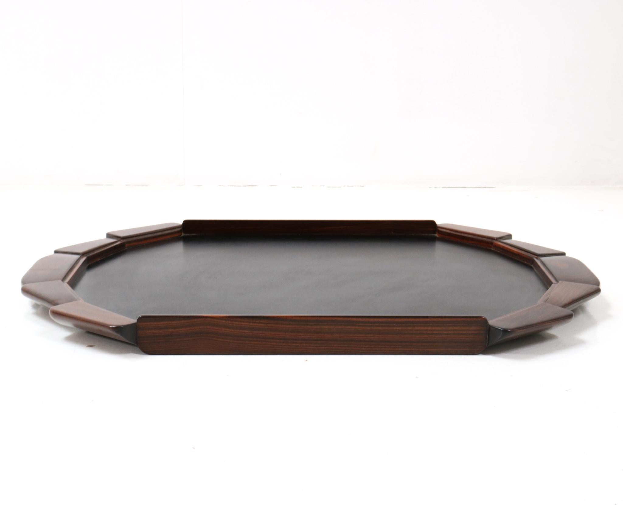 Magnificent and rare Art Deco serving tray.
Striking French design from the 1930s.
Solid macassar ebony frame with faux leather top.
This large and wonderful Art Deco serving tray is in very good condition with
minor wear consistent with age and
