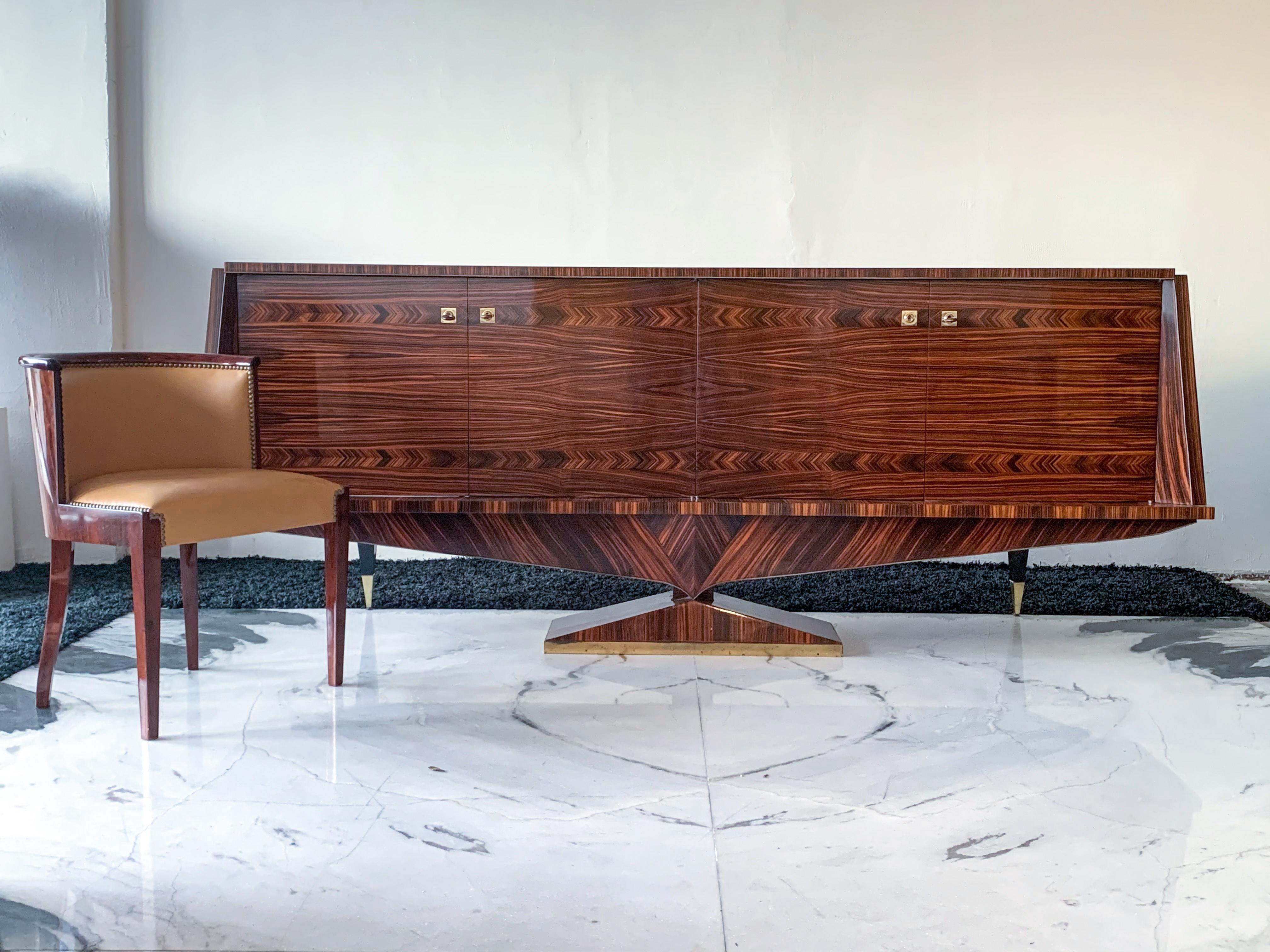 This credenza is an absolute showstopper! It's equal parts Mid-Century Modern and Art Deco refined into an elegantly shaped, oversized credenza. This credenza is completely clad in rare Macassar ebony wood -- similar to rosewood.

The credenza