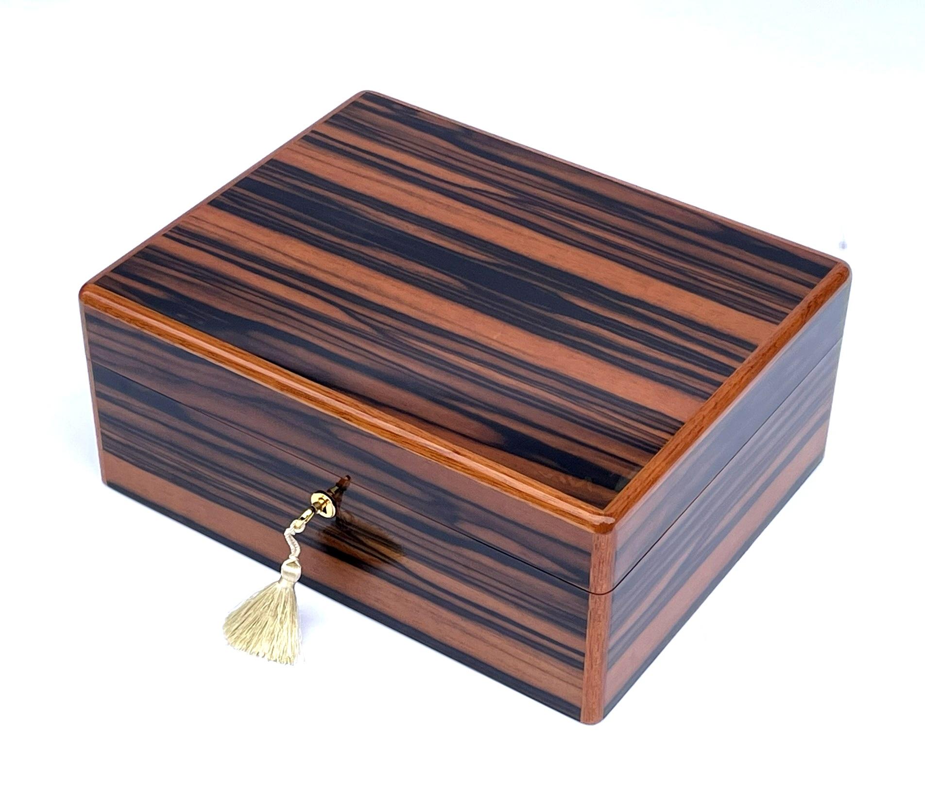 Stunning Macassar Ebony Ladys or Gentlemans Jewellery Casket was manufactured by the famed Manning  Co. of Ireland  and is truly a jewel of handcrafted genius. This box is constructed of the finest woods available and the knowledge and skill of 4